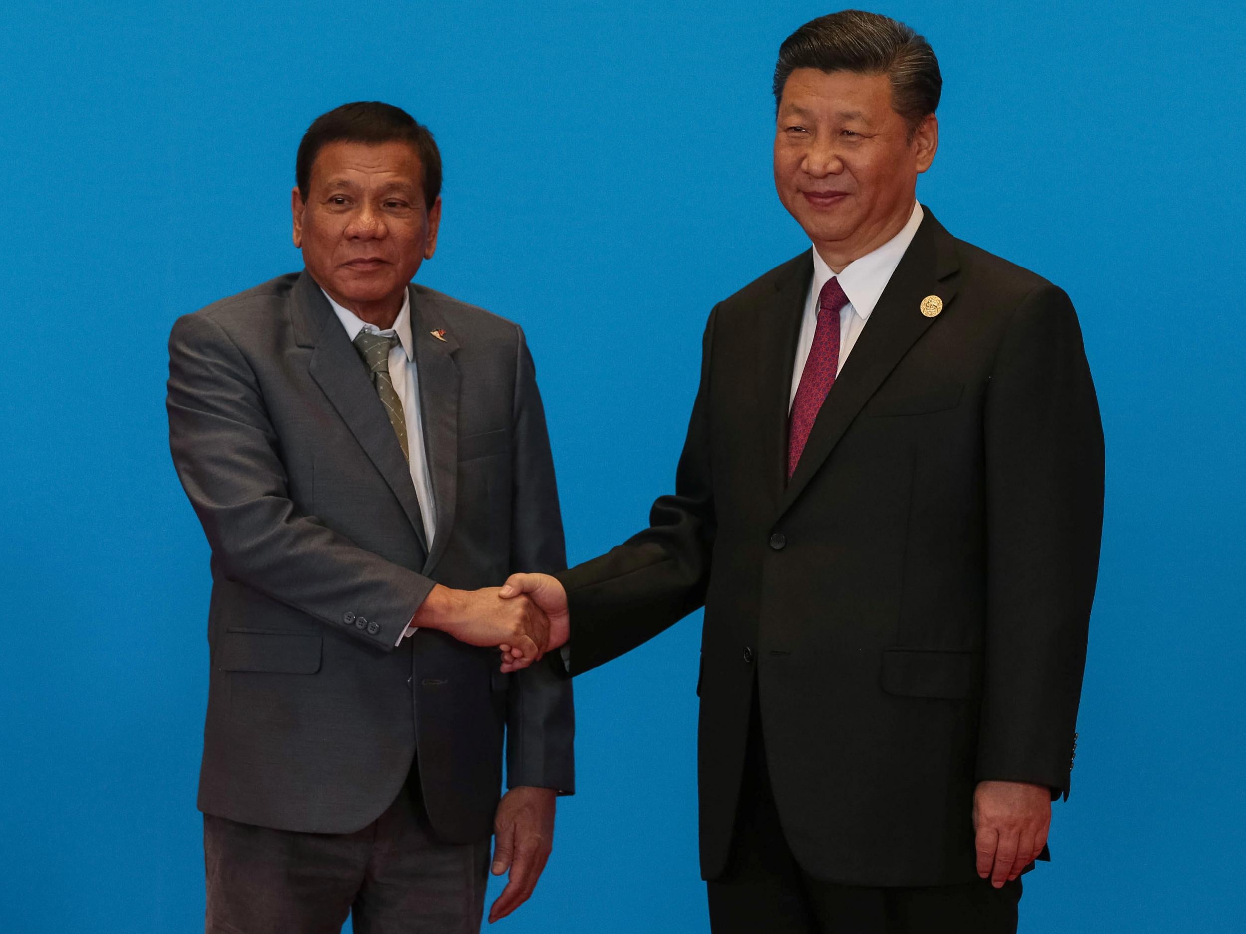 Philippine President Rodrigo Duterte shakes hands with Chinese President Xi Jinping in Beijing on 15 May 2017