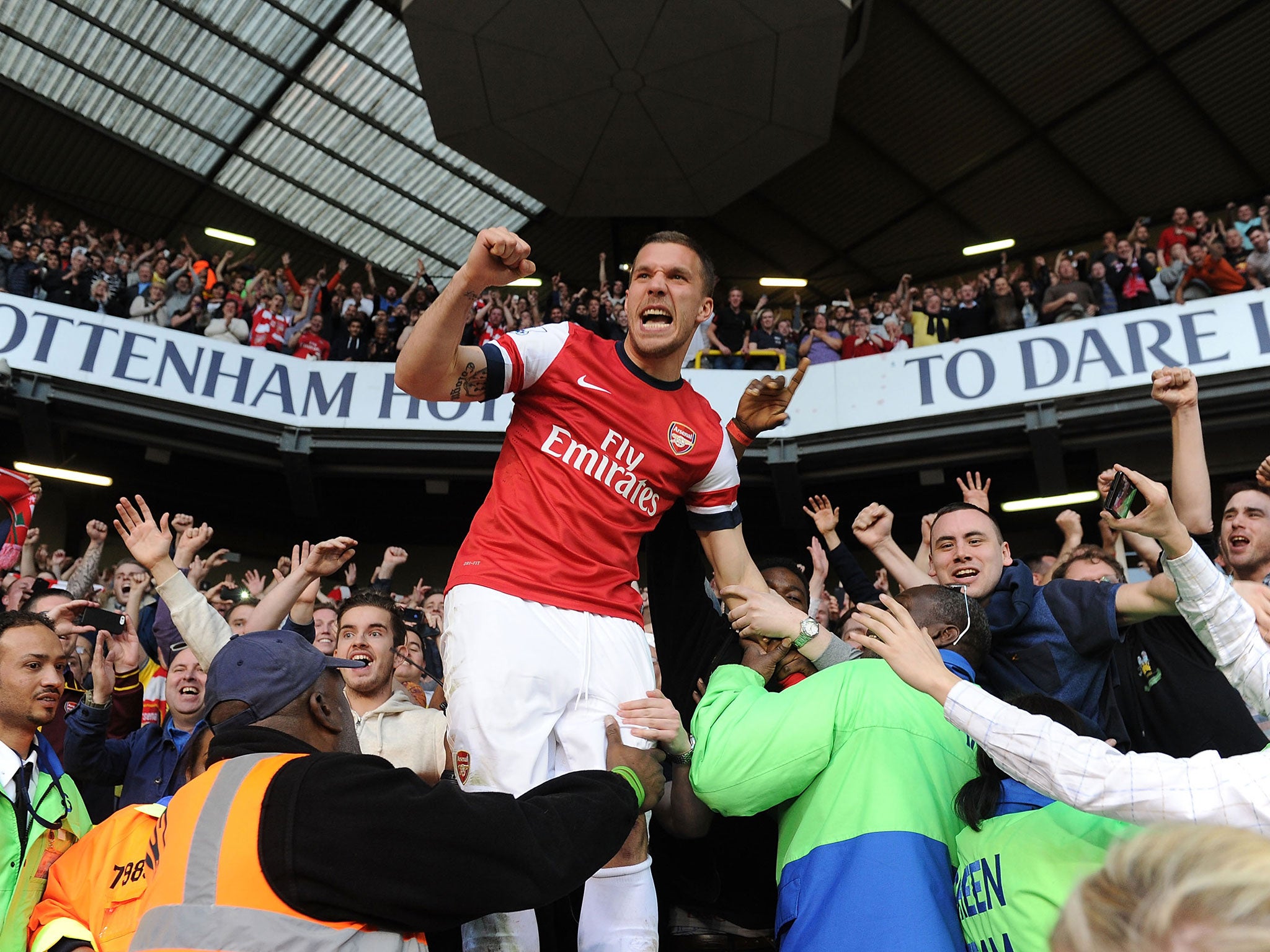 Lukas Podolski celebrates with Arsenal fans at White Hart Lane after beating Spurs in 2014