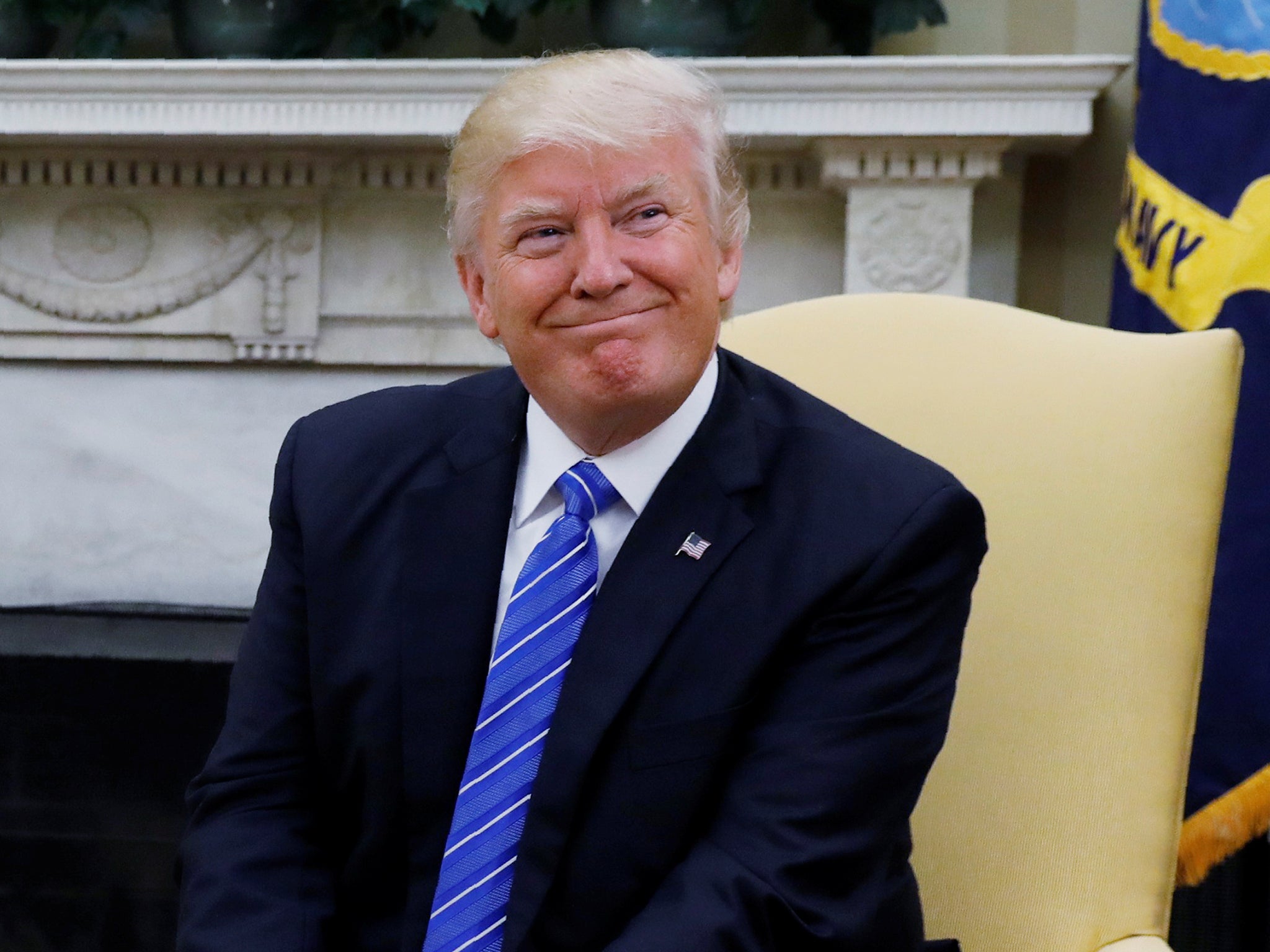 President Donald Trump listens to questions from the media in the Oval Office