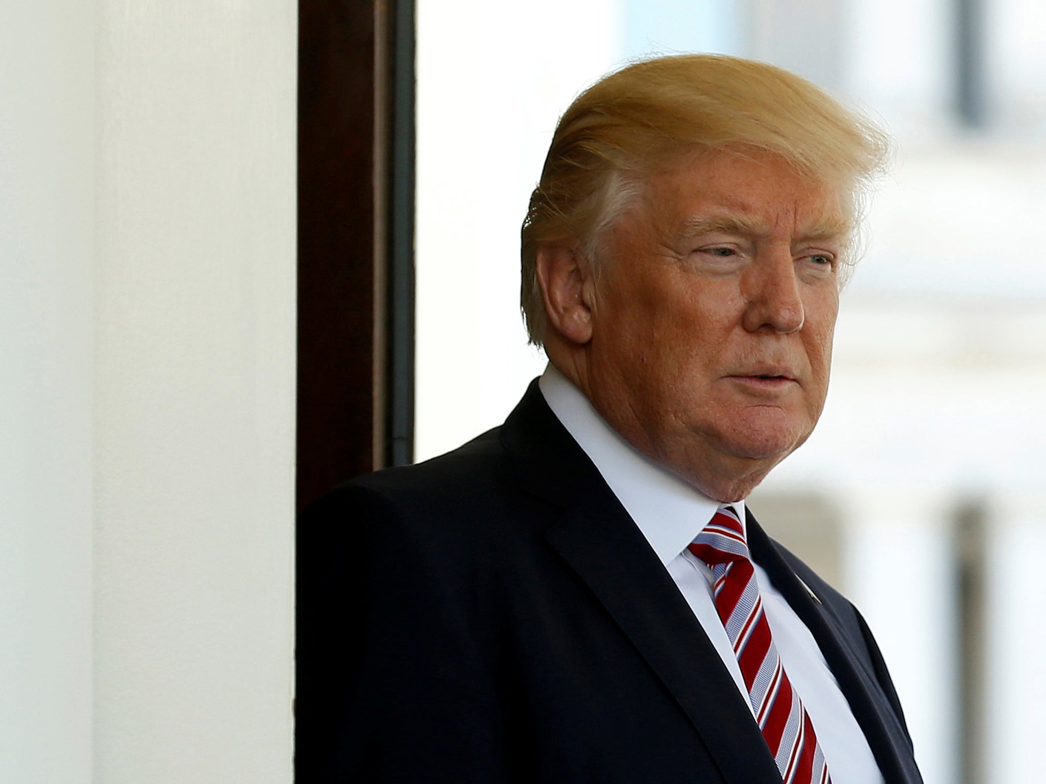 President Donald Trump watches as Turkey's President Recep Tayyip Erdogan departs at the entrance to the West Wing of the White House