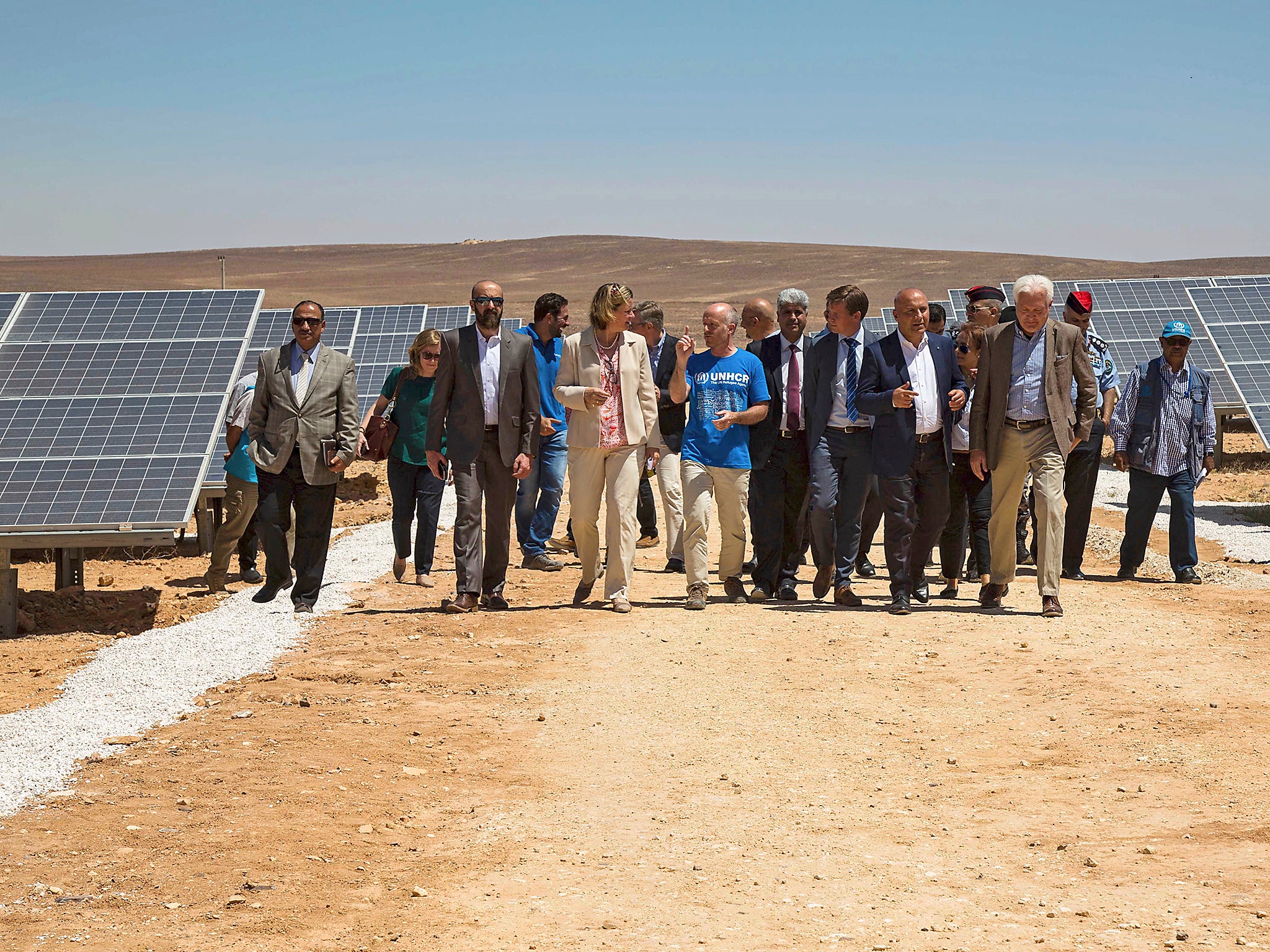 Officials from the IKEA Foundation, and the U.N. refugee agency tour a newly inaugurated solar energy plant, that will provide about 20,000 Syrian refugees with electricity, in the Azraq Refugee Camp, Jordan