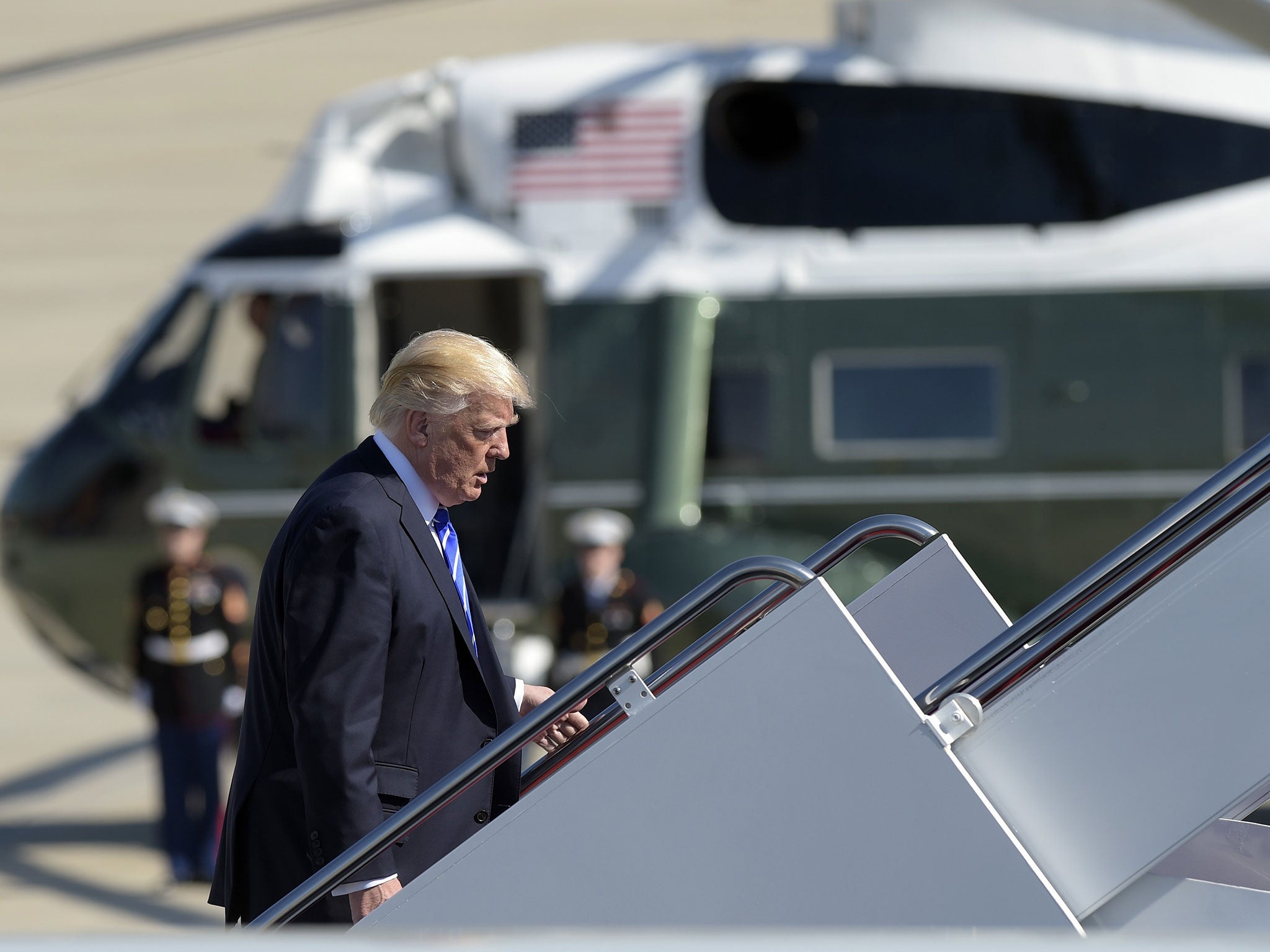 President Donald Trump walks up the steps of Air Force One at Andrews Air Force Base on Wednesday