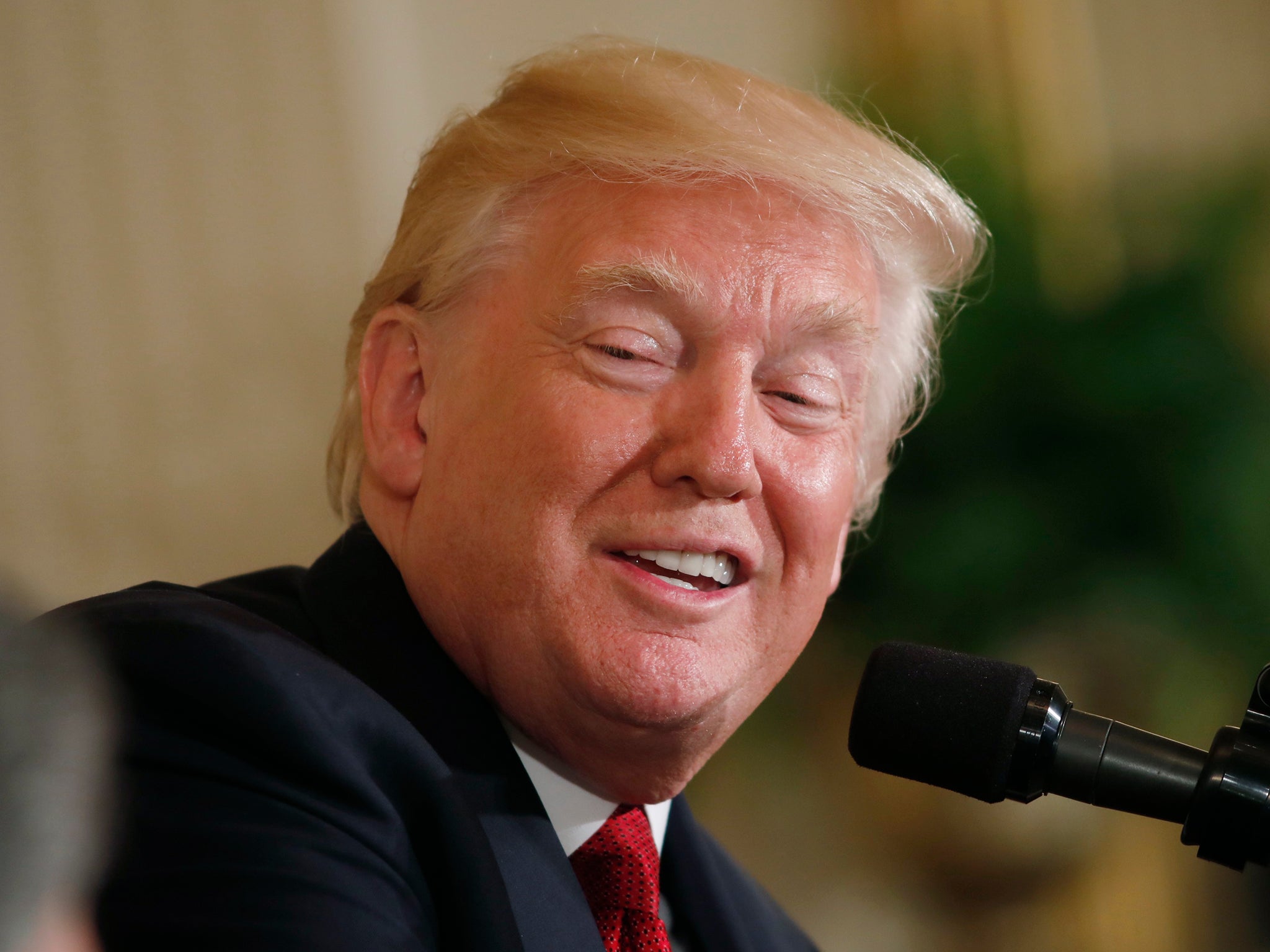 President Donald Trump looks over at Colombia's President Juan Manuel Santos during their joint news conference at the White House in Washington