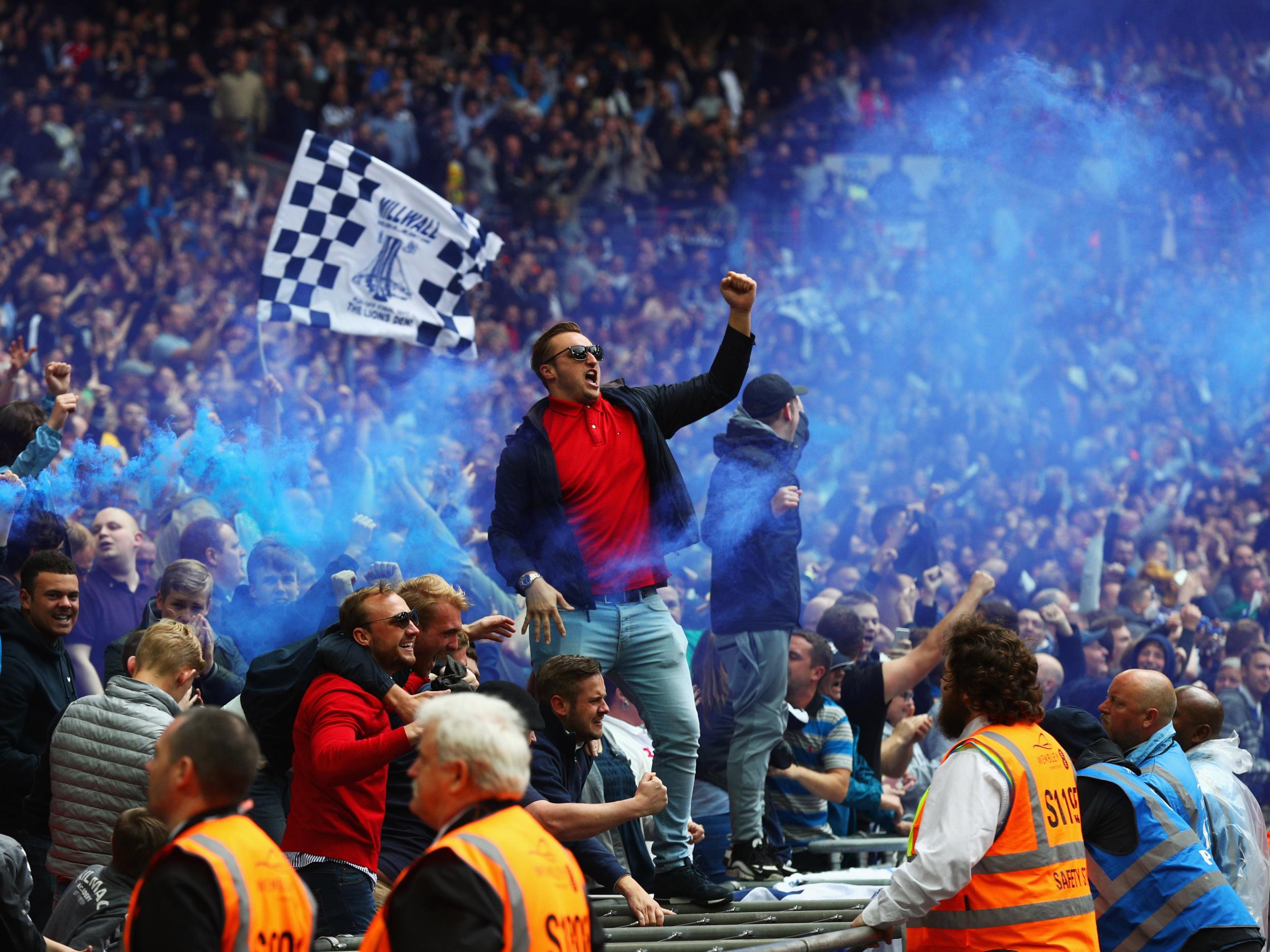 A pair of Millwall fans lead the celebrations