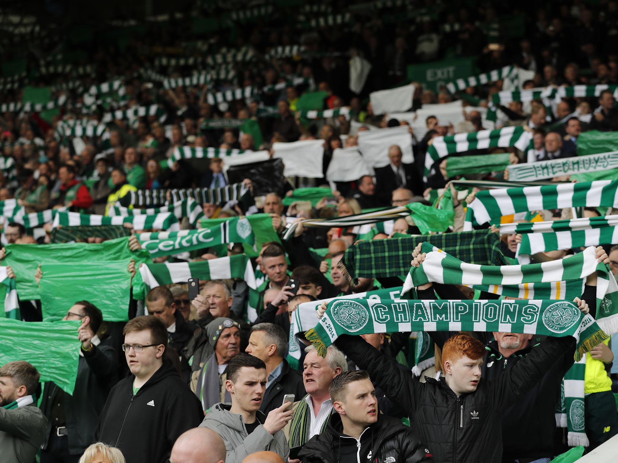 Celtic supporters celebrate their remarkable undefeated run (Getty)