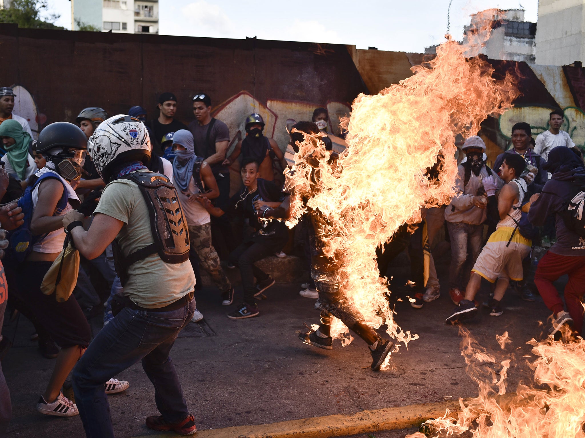 Opposition demonstrators set on fire Orlando Figuera during a protest against the government of President Nicolas Maduro in Caraca