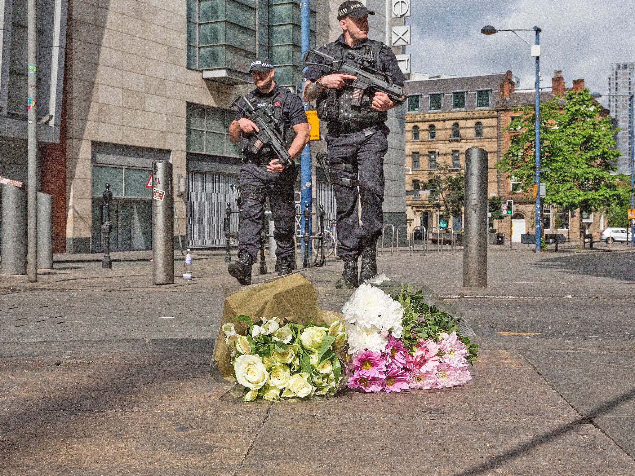 Armed police patrol in Shudehill, Manchester, today