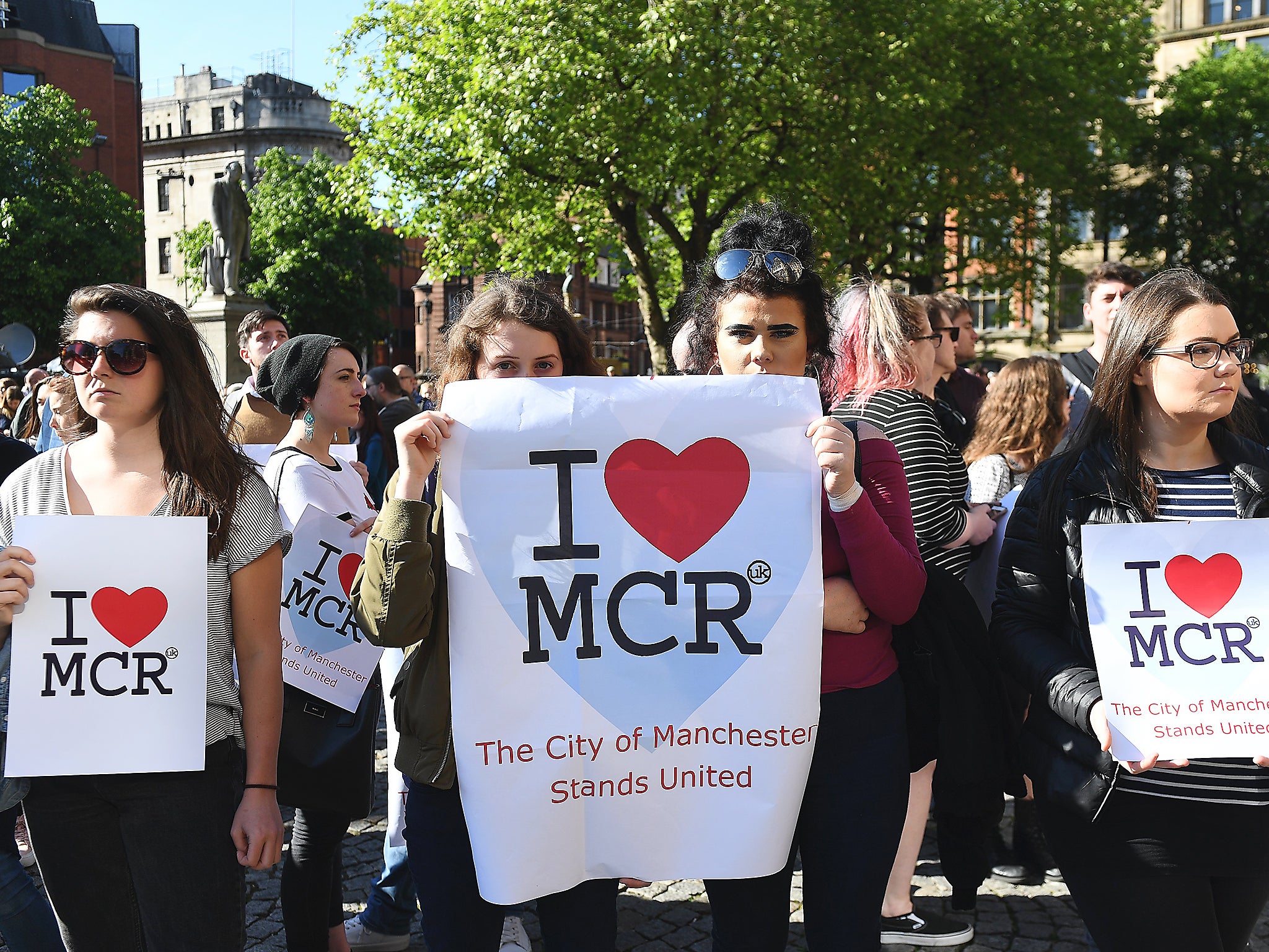 People attend a vigil for the people who lost their lives during the Manchester terror attack in central Manchester