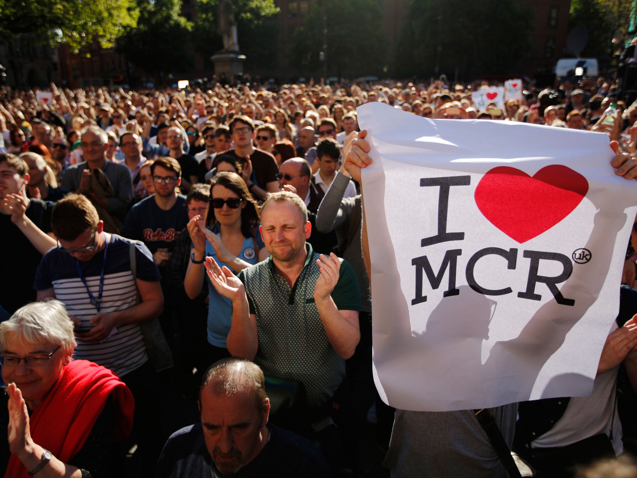 Crowds gather for a vigil in Albert Square