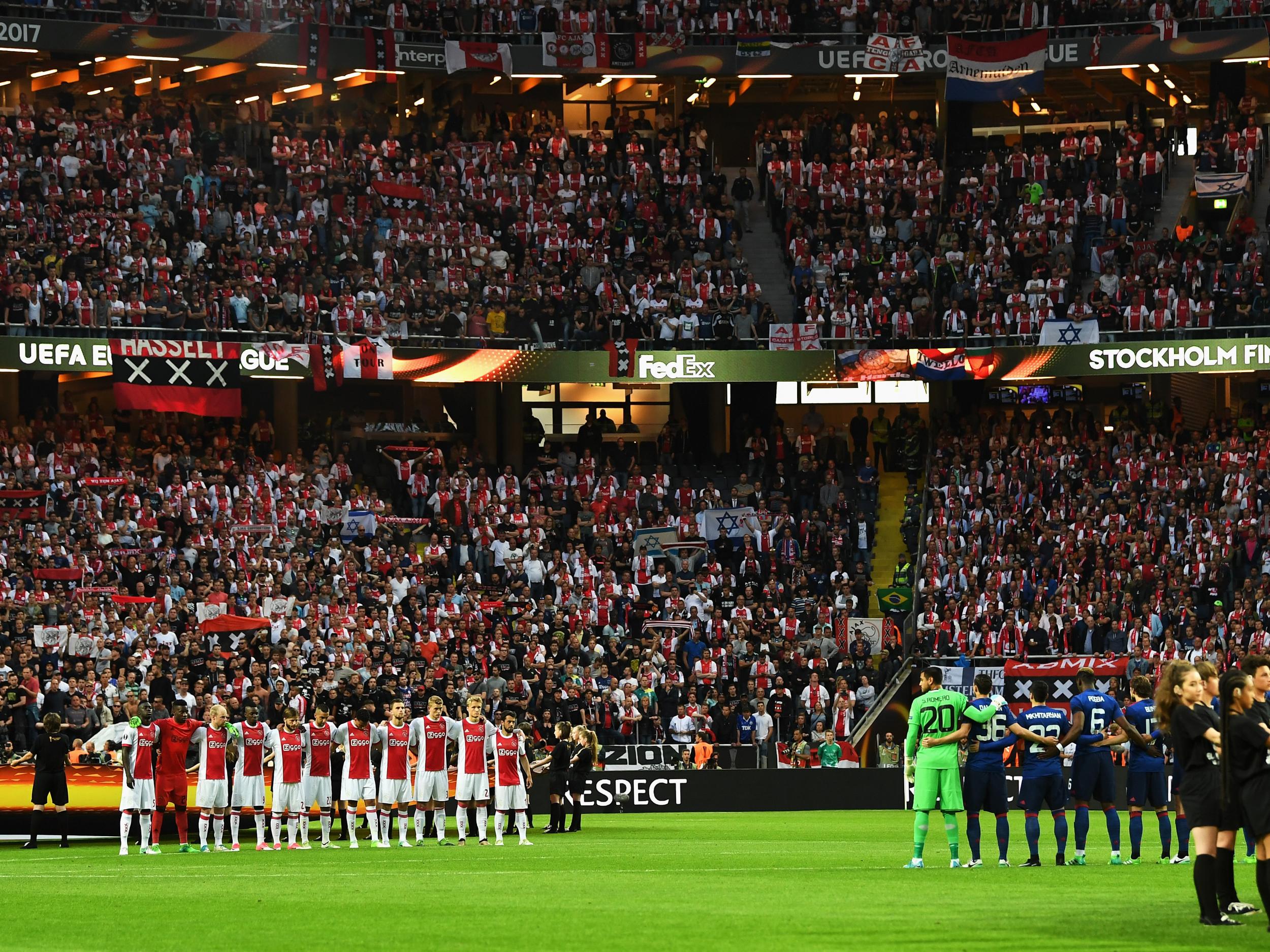 United and Ajax players observing a minute's silence