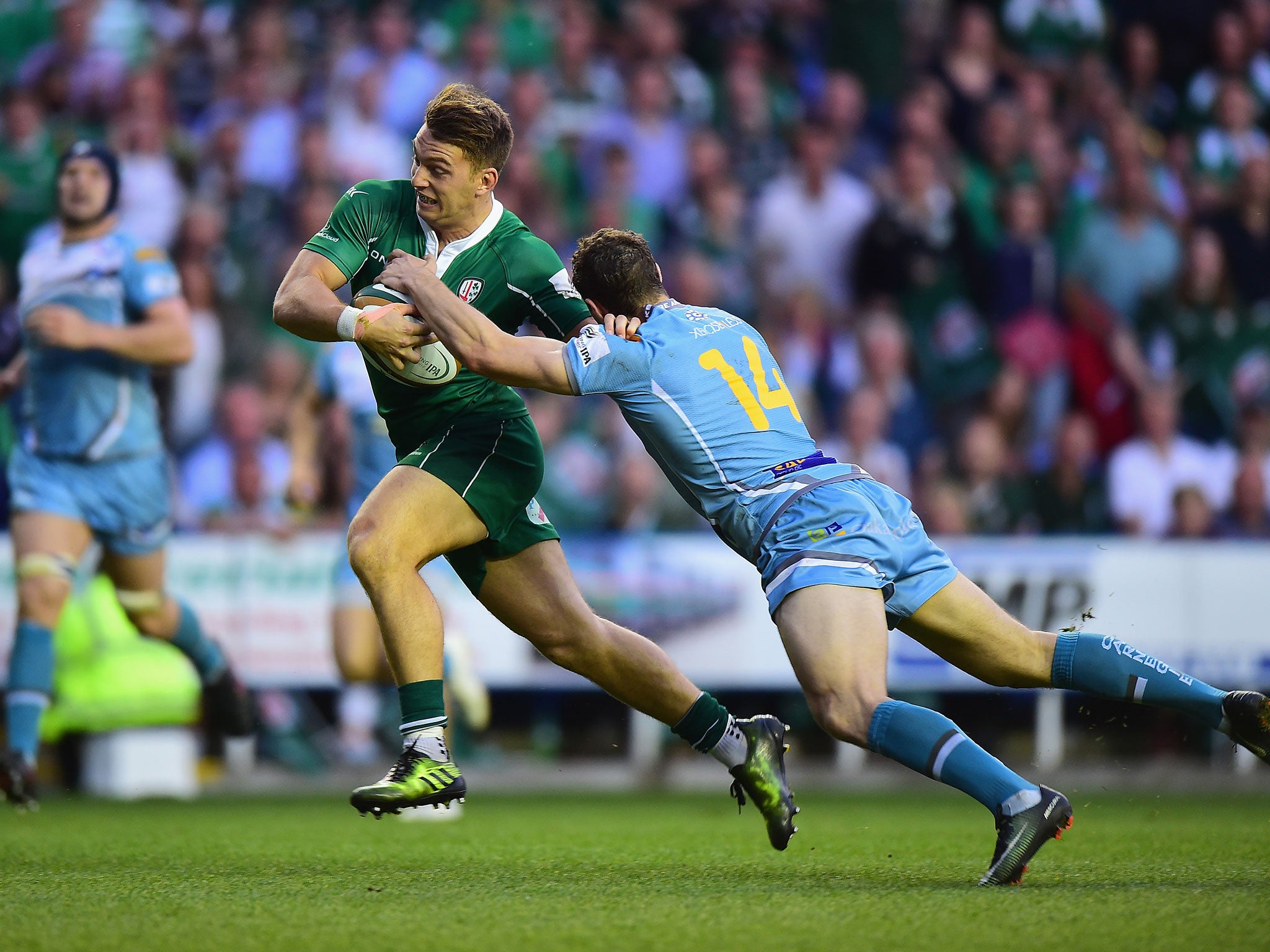 Alex Lewington holds off a tackle from Johan Holmes