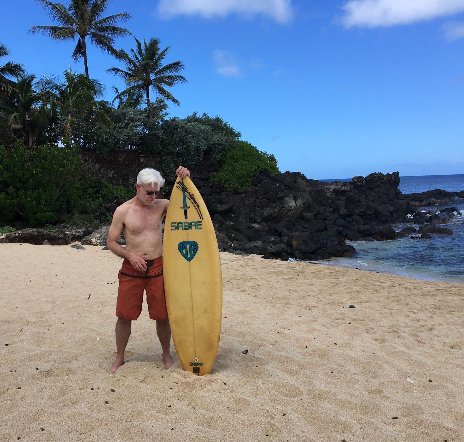 Andy Martin in Hawaii with Deerhurst’s board. Witness the Excalibur logo: to Ted, surfing was heroic, surfers knight-errants in shorts...