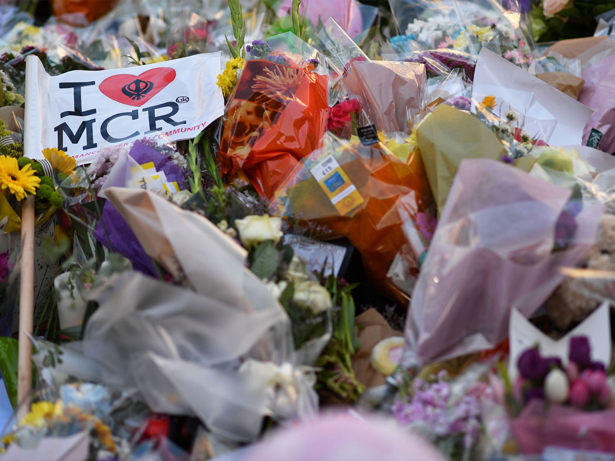 Flowers, messages and candles are pictured in St Ann's Square in Manchester in tribute to the victims of the terror attack