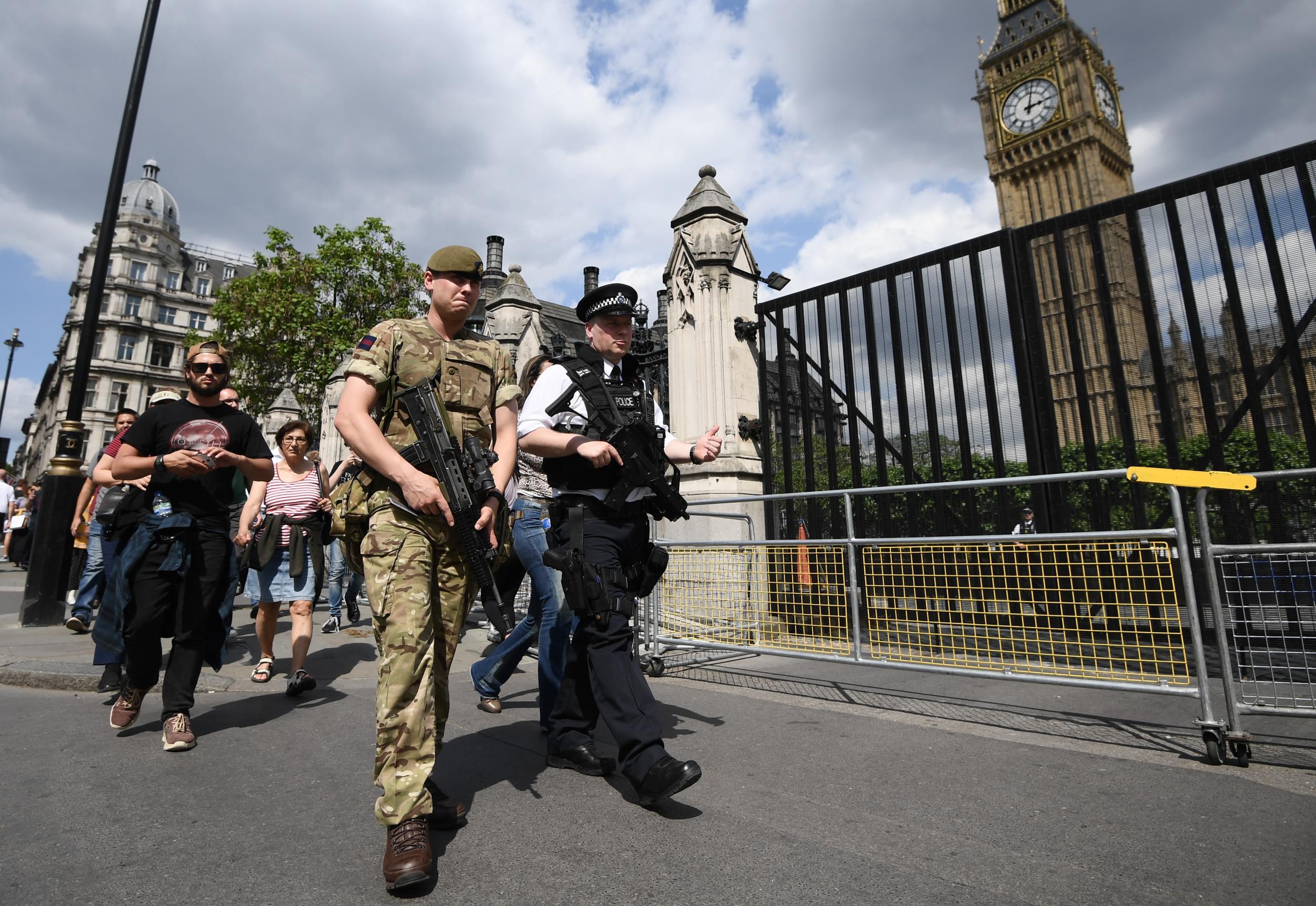 Soldiers reinforce police outside the Palace of Westminster in London