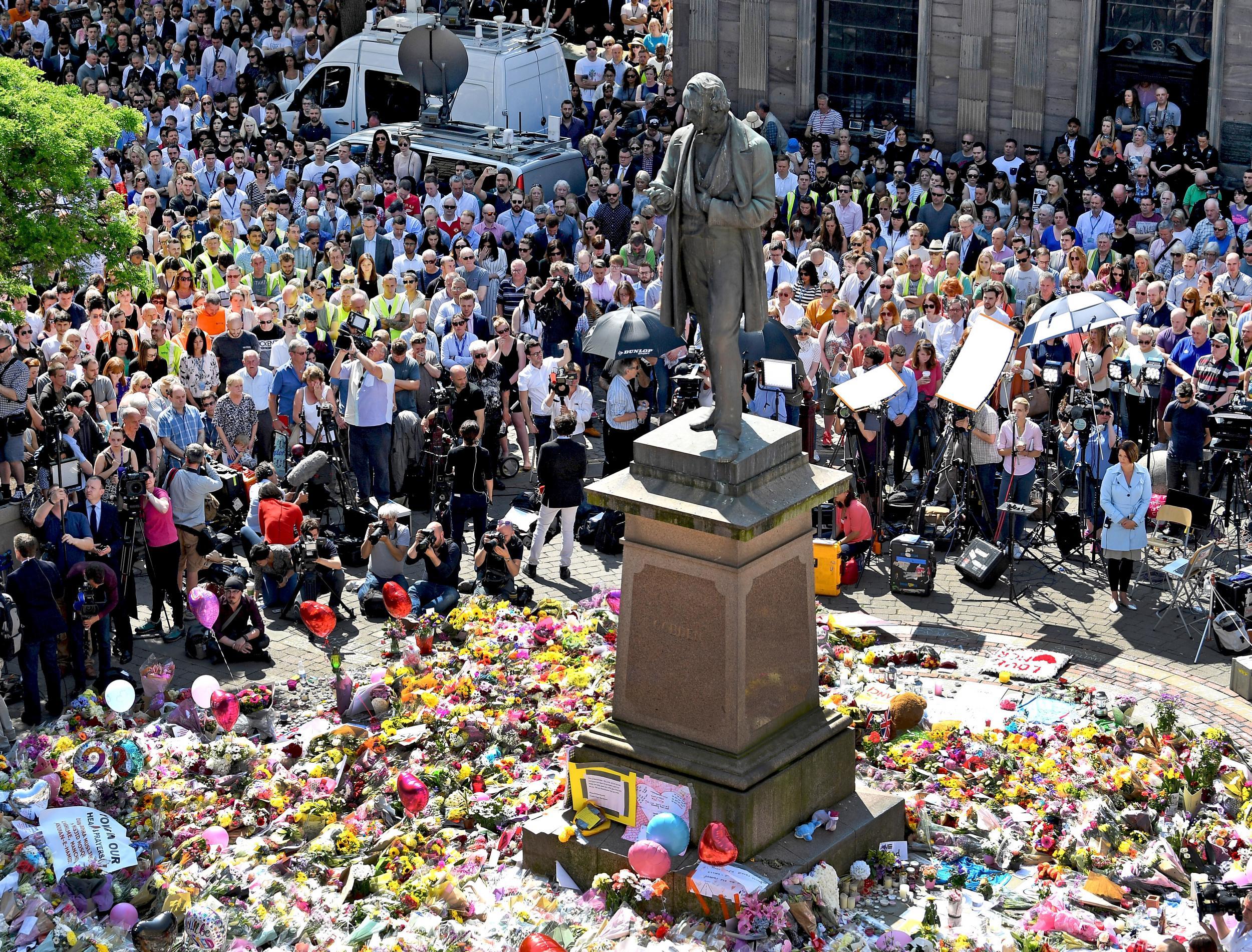 Members of the public observe a national minute's silence in remembrance of all those who lost their lives in the Manchester Arena attack