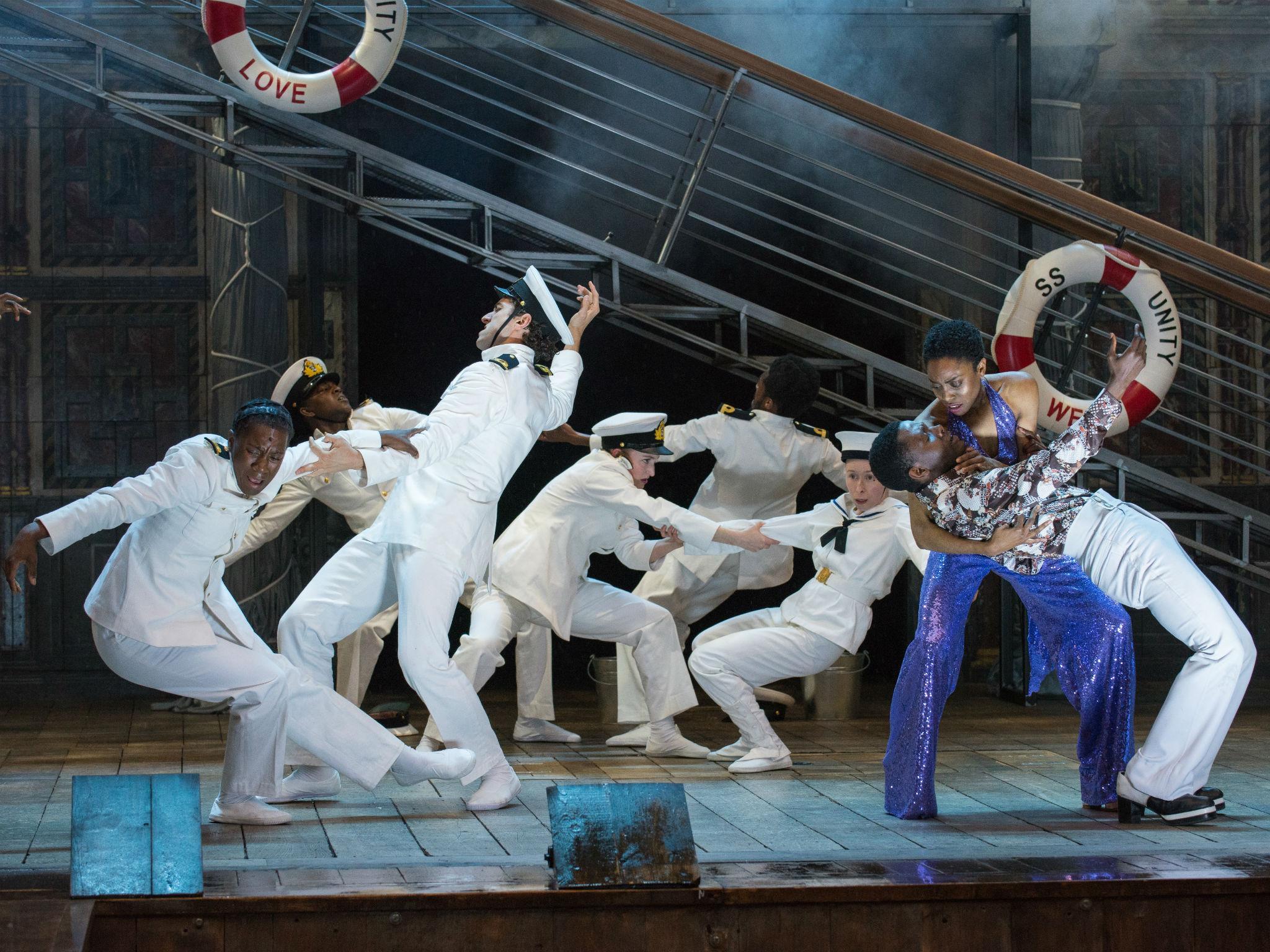 The full company of sailors with John Pfumojena and Anita-Joy Uwajeh in Emma Rice's discofied Shakespeare revival