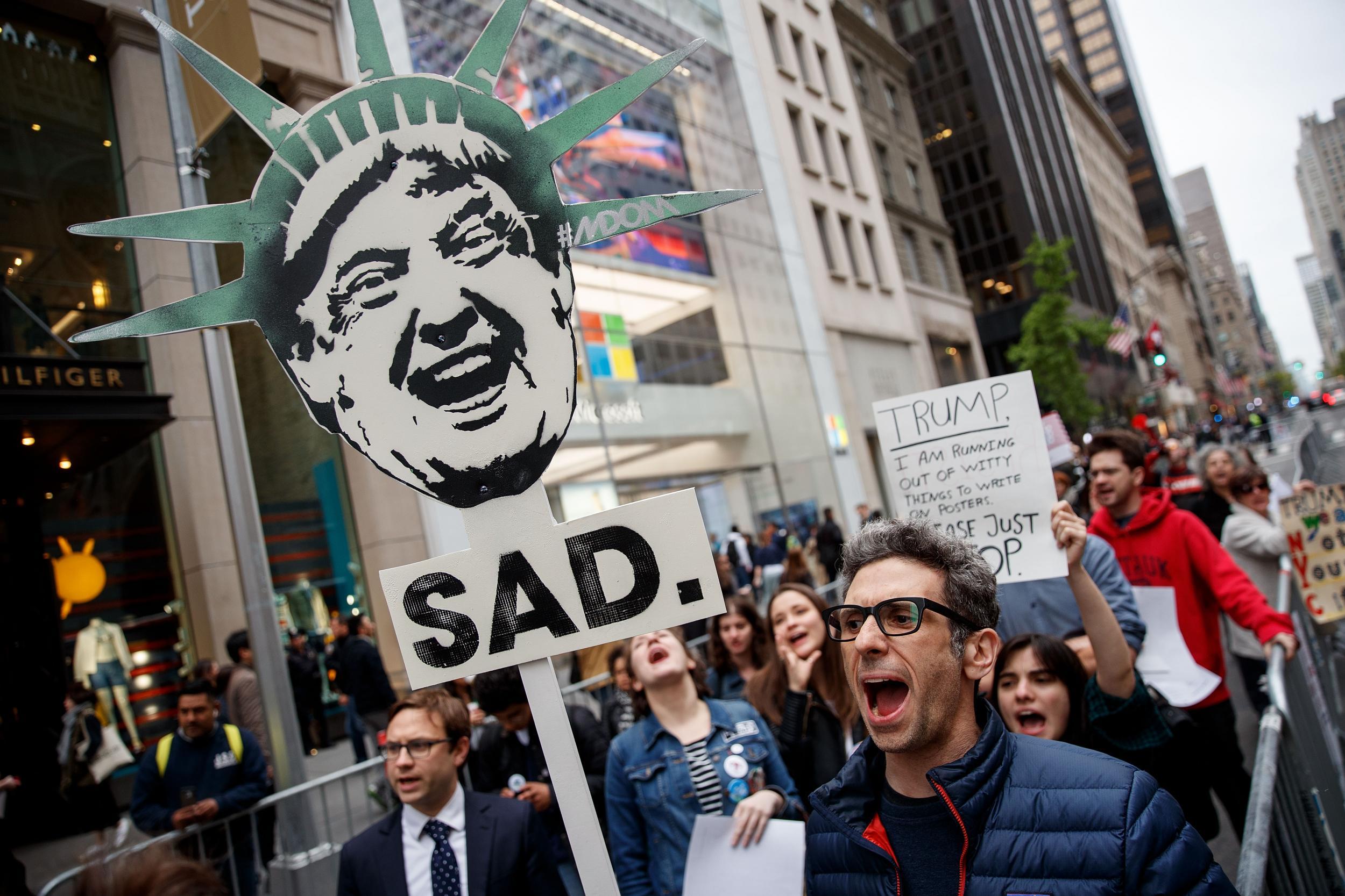 Protestors rally against President Donald Trump and his policies down the street from Trump Tower