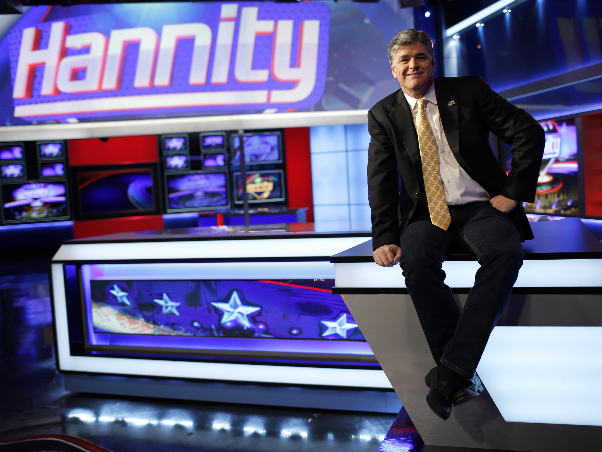 Fox News Channel anchor Sean Hannity poses for photographs on the set of his show during happier times