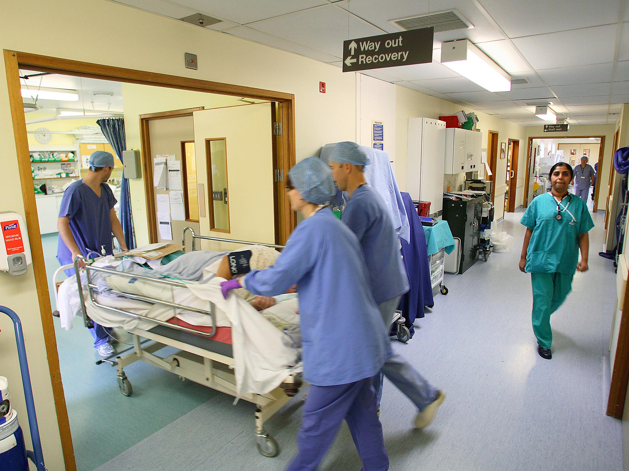 Hospital staff transporting a patient on a trolley