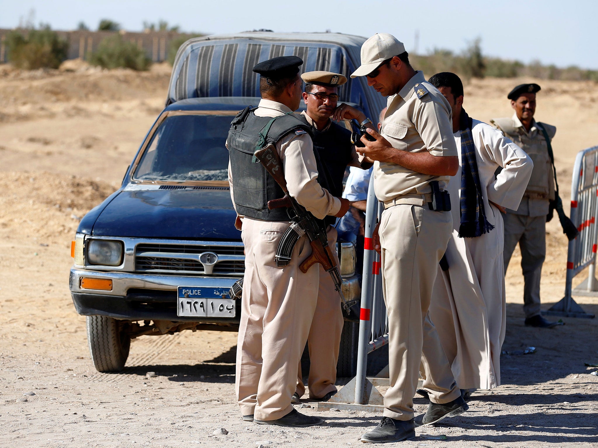 Security guards stand near the site of an attack in Minya, Egypt, on 26 May