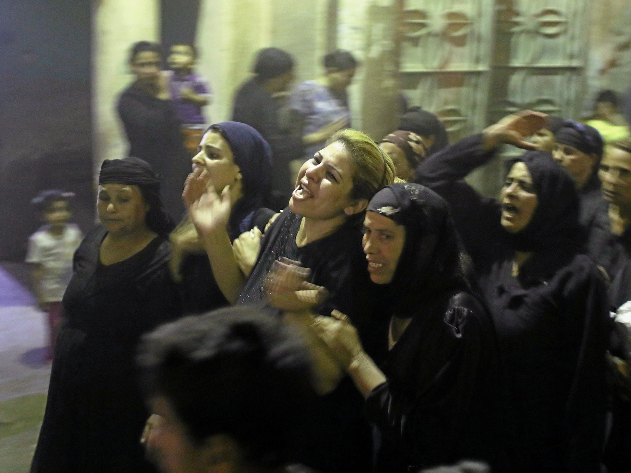 Mourners react after the funeral of Coptic Christians who were killed on Friday in Minya, Egypt (Reuters)