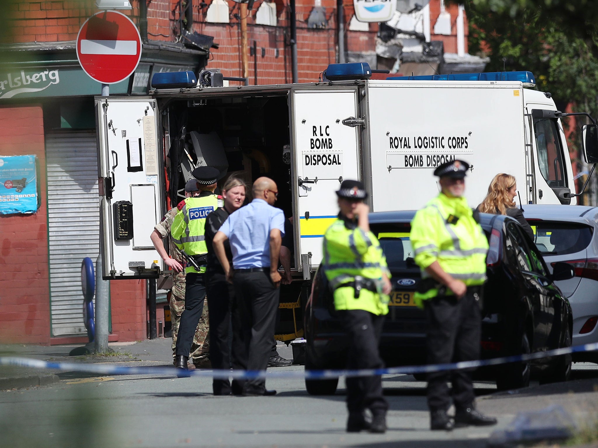 Armed officers at a cordon in Quantock Close, Moss Side, as fresh raids are carried out