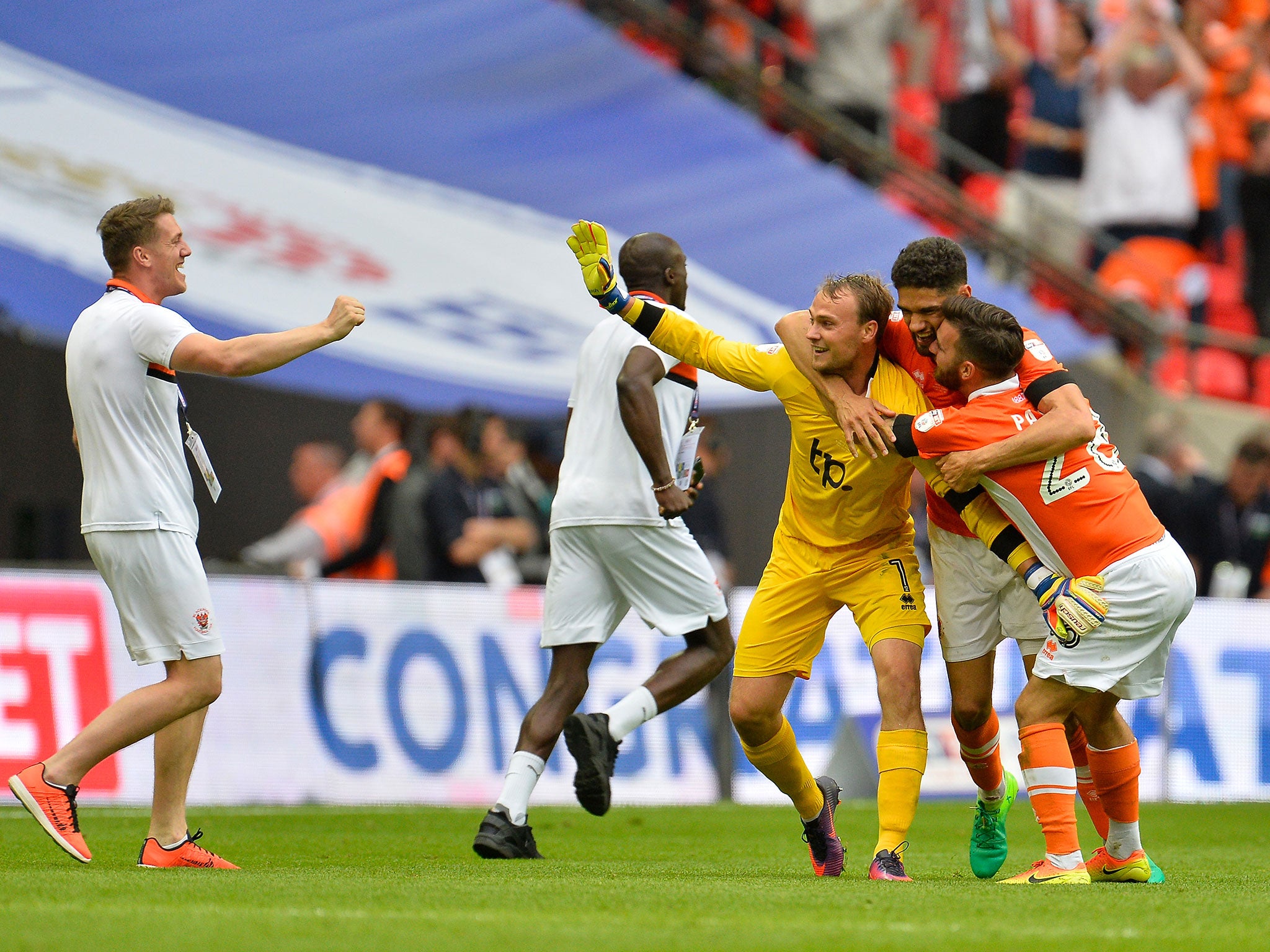 Blackpool's players celebrate securing their return to League One