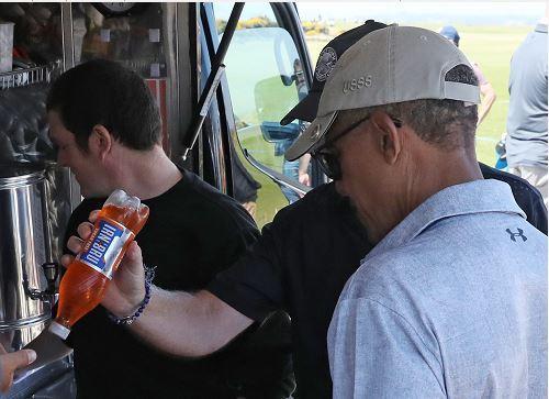 Barack Obama is handed an Irn Bru at Old Course, St Andrews