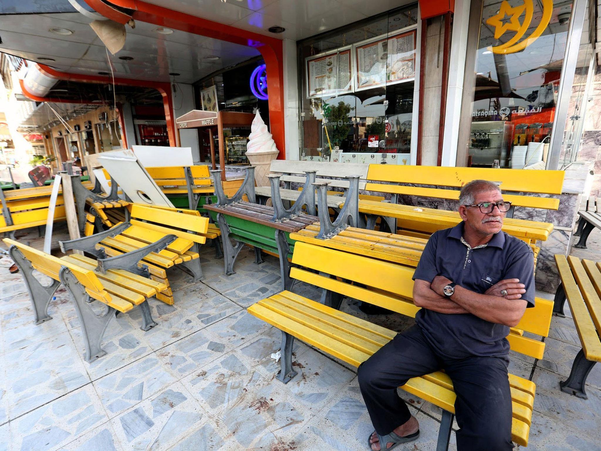 An Iraqi man looks over the site of bombing at Alfaqma ice cream shop in Karrada district, Baghdad, Iraq ( EPA/ALI ABBAS)