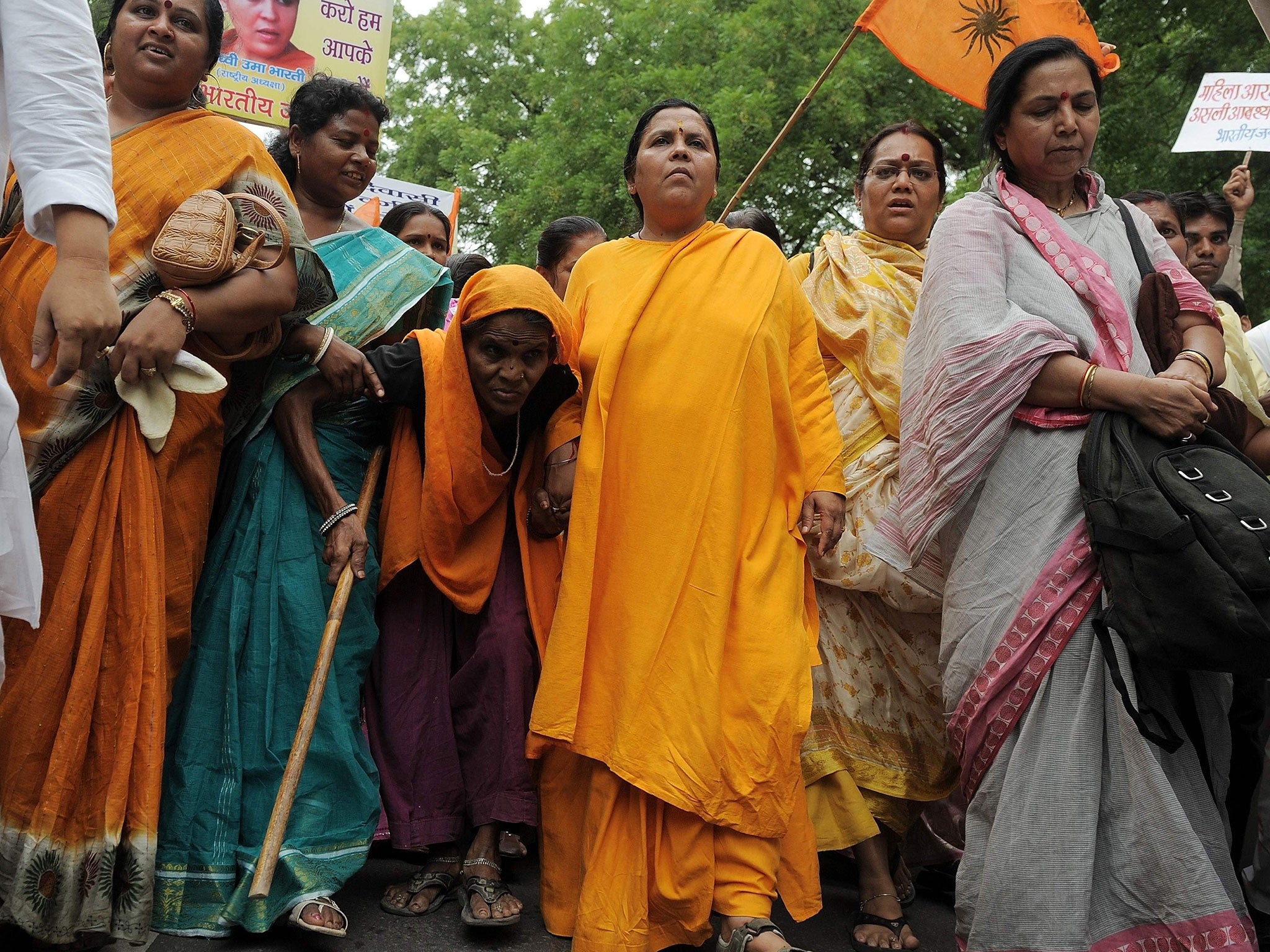 File photo shows Indian Bharatiya Janshakti Party (BJP) leader Uma Bharti (C) takes part in a rally in New Delhi