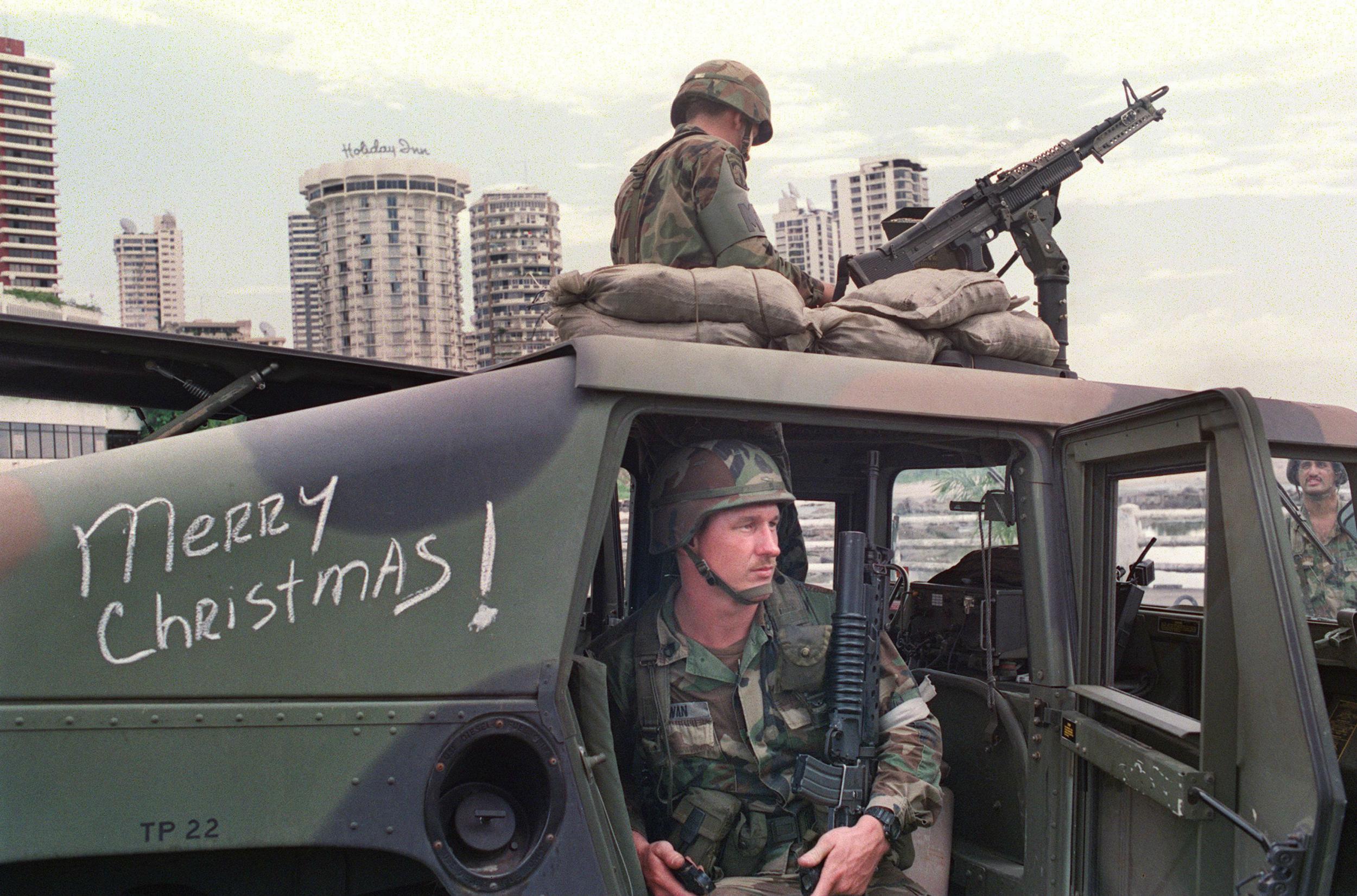 US soldiers man their security position outside the Vatican embassy in Panama City where Panamanian General Manuel Noriega sought asylum during Operation Just Cause, on December 25, 1989.