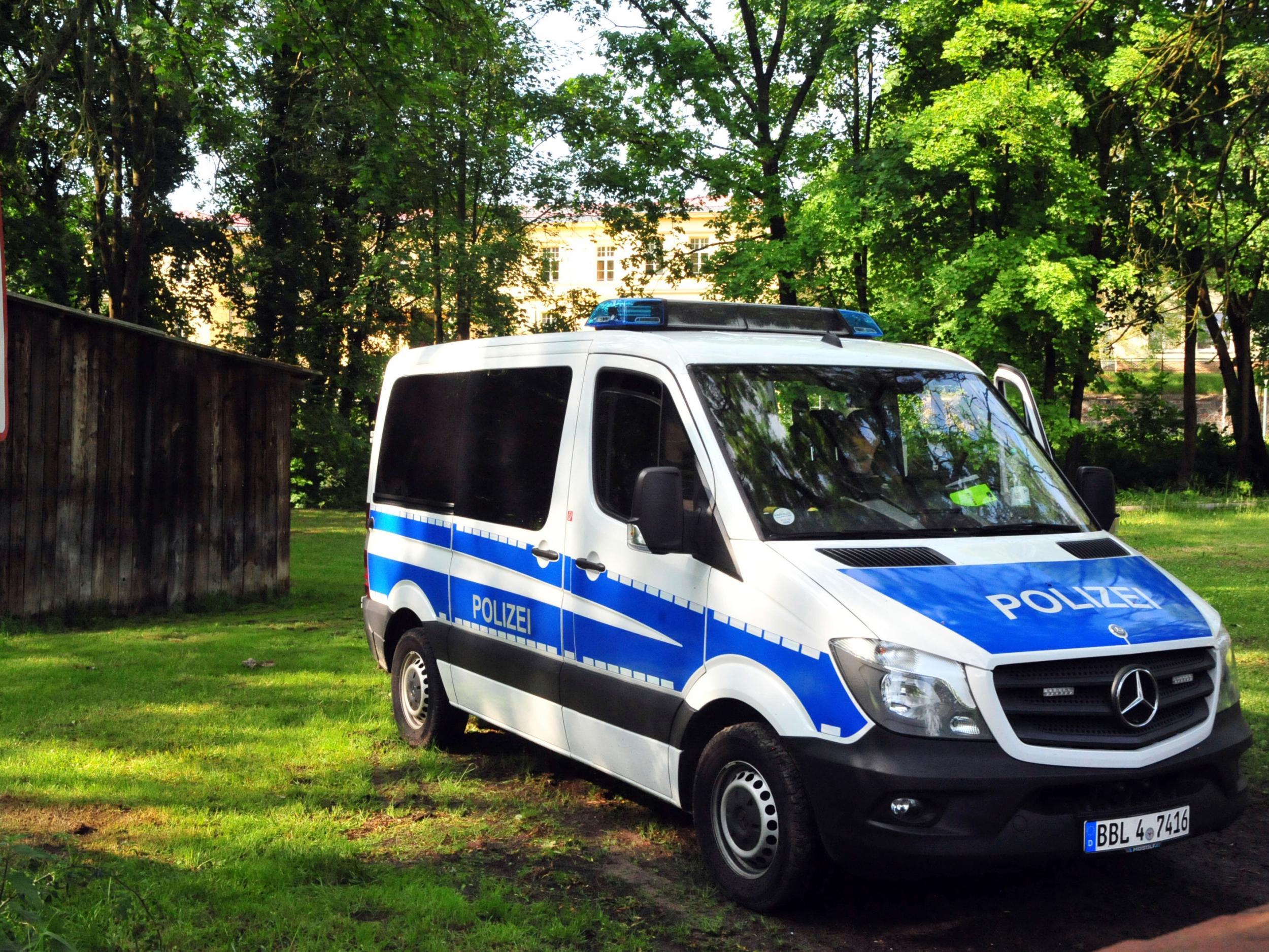 A police vehicle stands in front of a youth center in Gerswalde, Germany, where an asylum seeker was arrested after officers susptected he was planning a suicide attack in Berlin