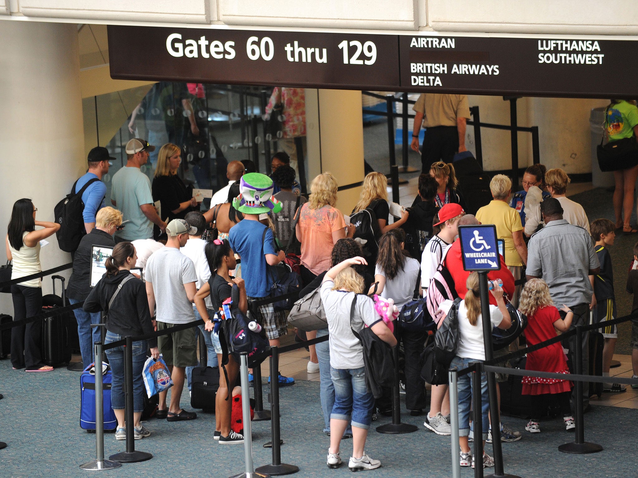 Airline passengers pass through security May 2, 2011 at Orlando International Airport in Orlando, Florida.