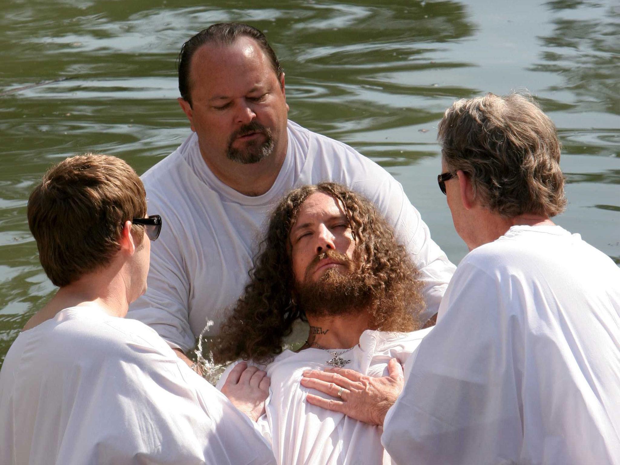 Brian 'Head' Welch, centre, being baptised in the Jordan river mere weeks after quitting Korn