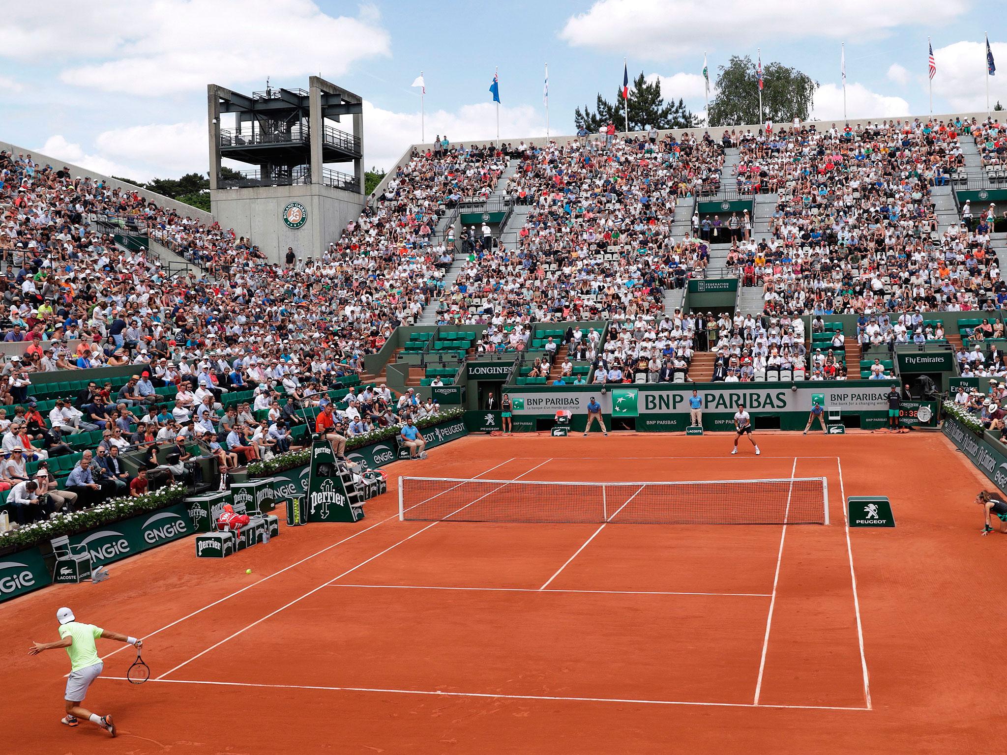 &#13; Sousa returns a Djokovic shot in the second set &#13;