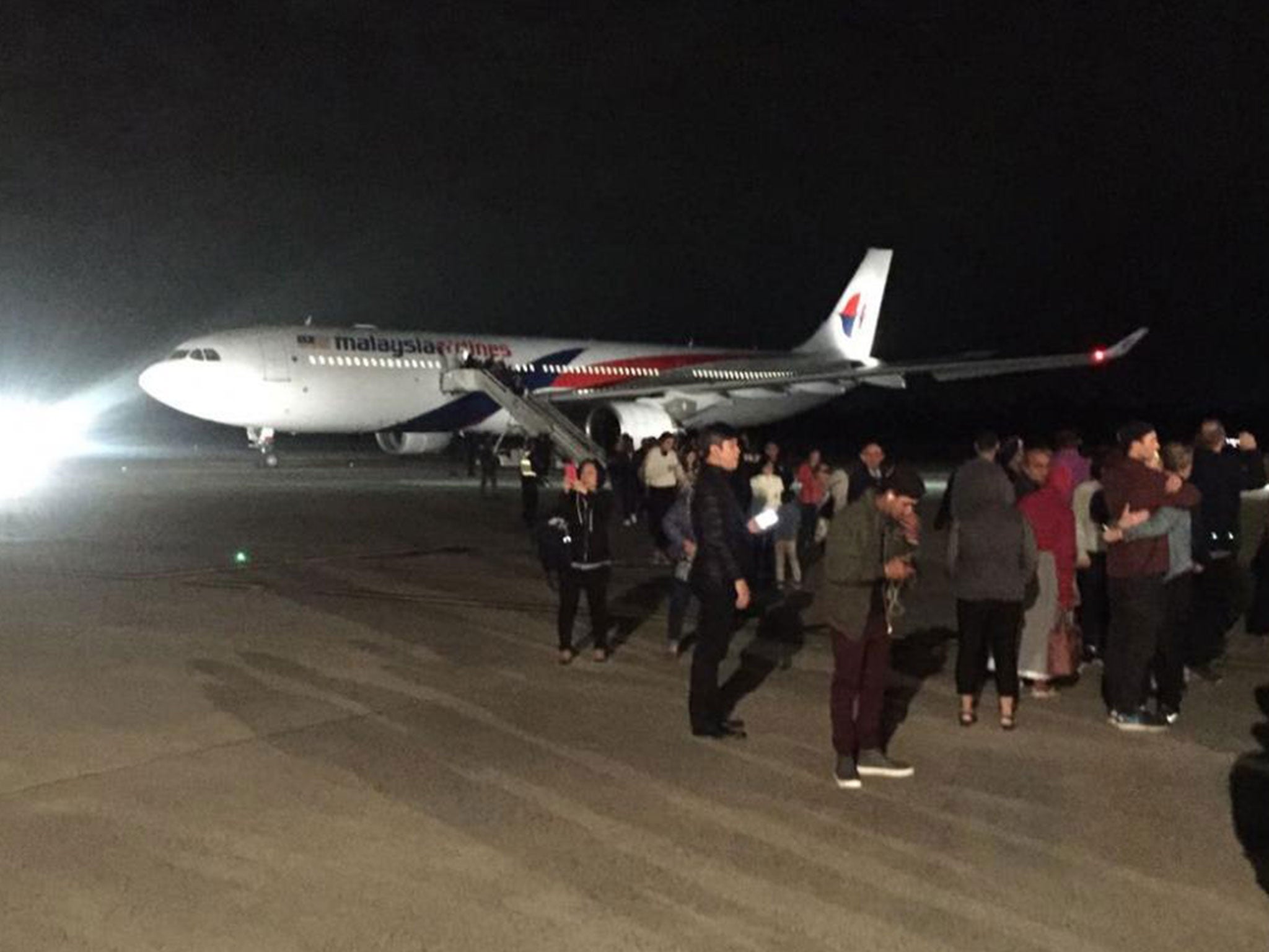 Passengers at Melbourne Airport after being disembarked from a Malaysia Airlines plane on 1 June