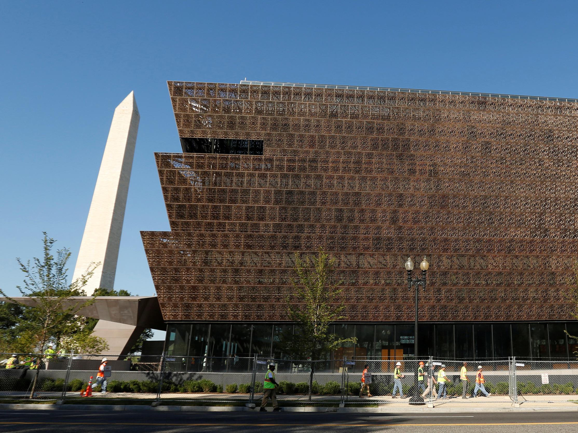 The Washington Monument rises behind the National Museum of African American History and Culture on the National Mall in Washington