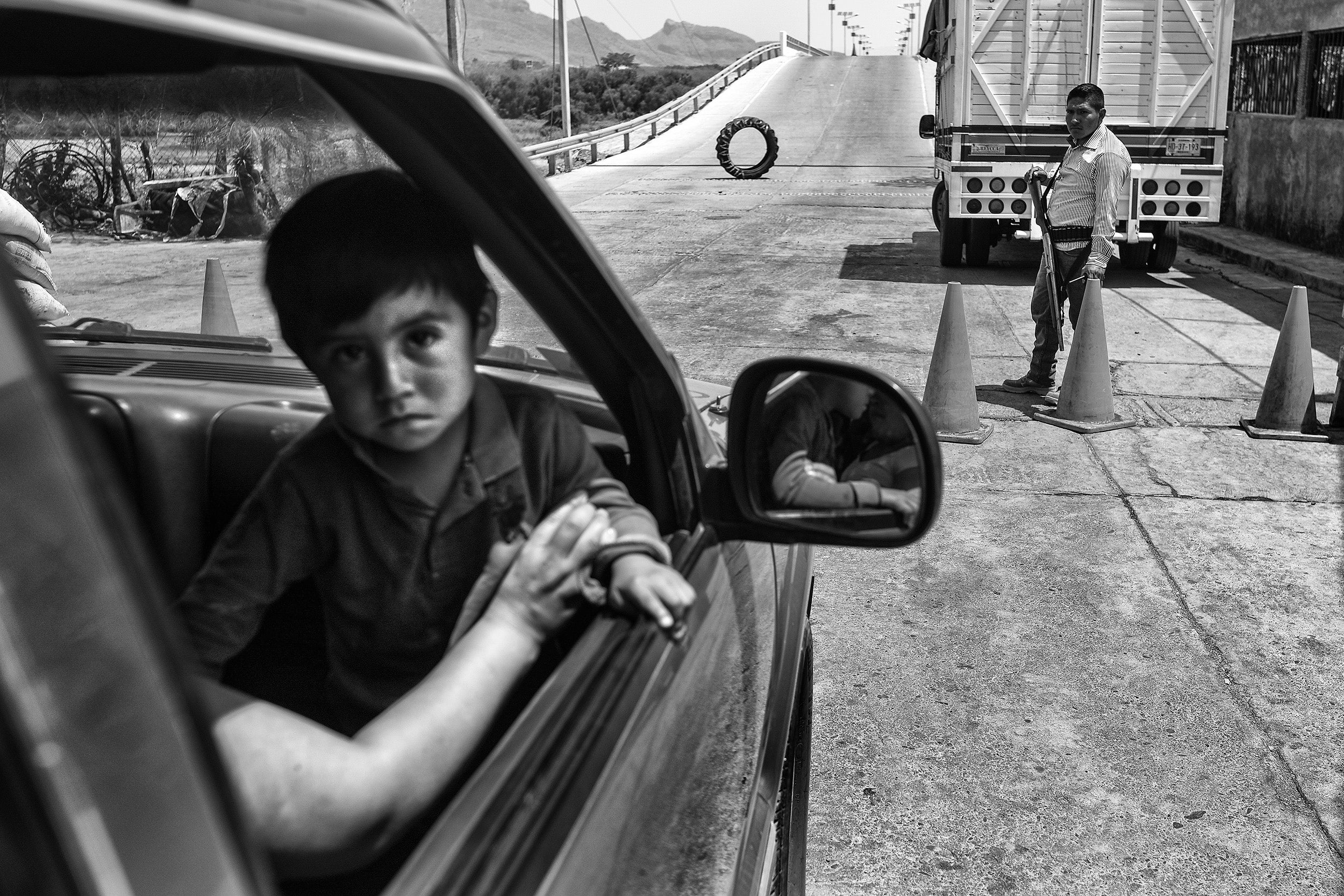 &#13;
A boy sits in a pickup truck at a citizen militia checkpoint in San Miguel Totolapan&#13;