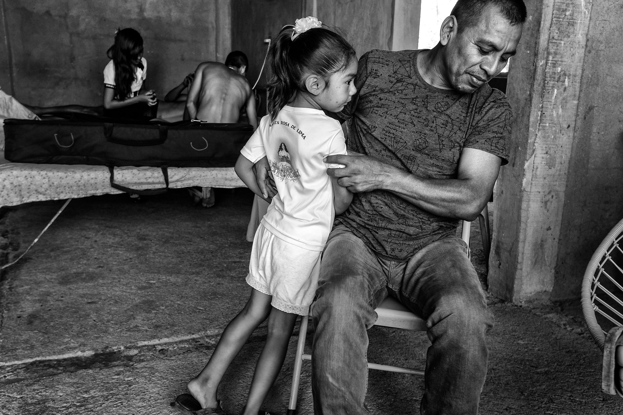 &#13;
Maurilio Mendoza holds his niece in his home in the town of Santa Rosa de Lima&#13;