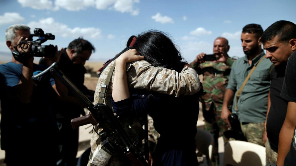 Nadia Murad hugs her brother Saeed as she visits her village for the first time after being captured and sold as a slave by Isis