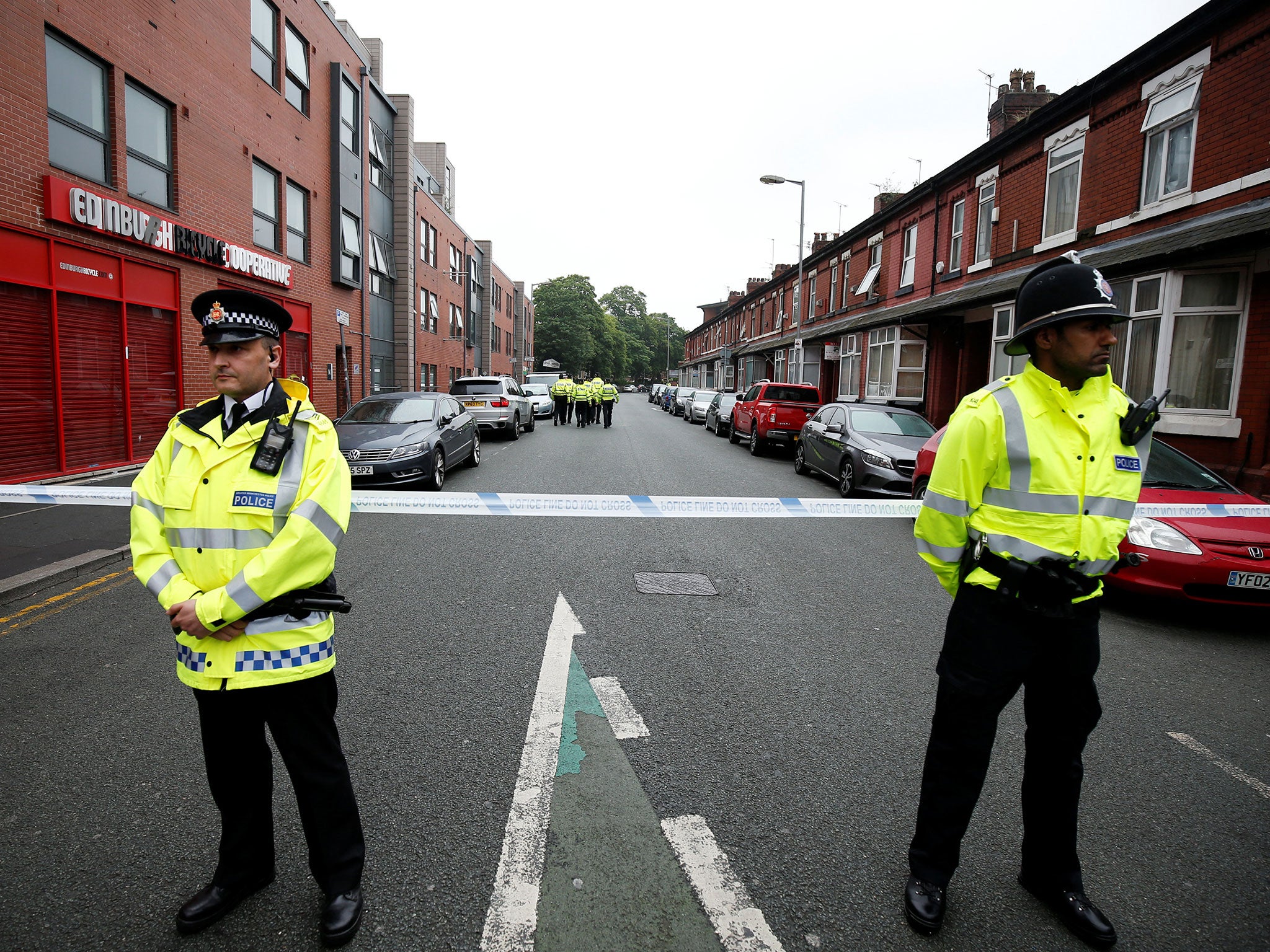 Police stand in front of a cordon in Rusholme, Manchester, on 2 June