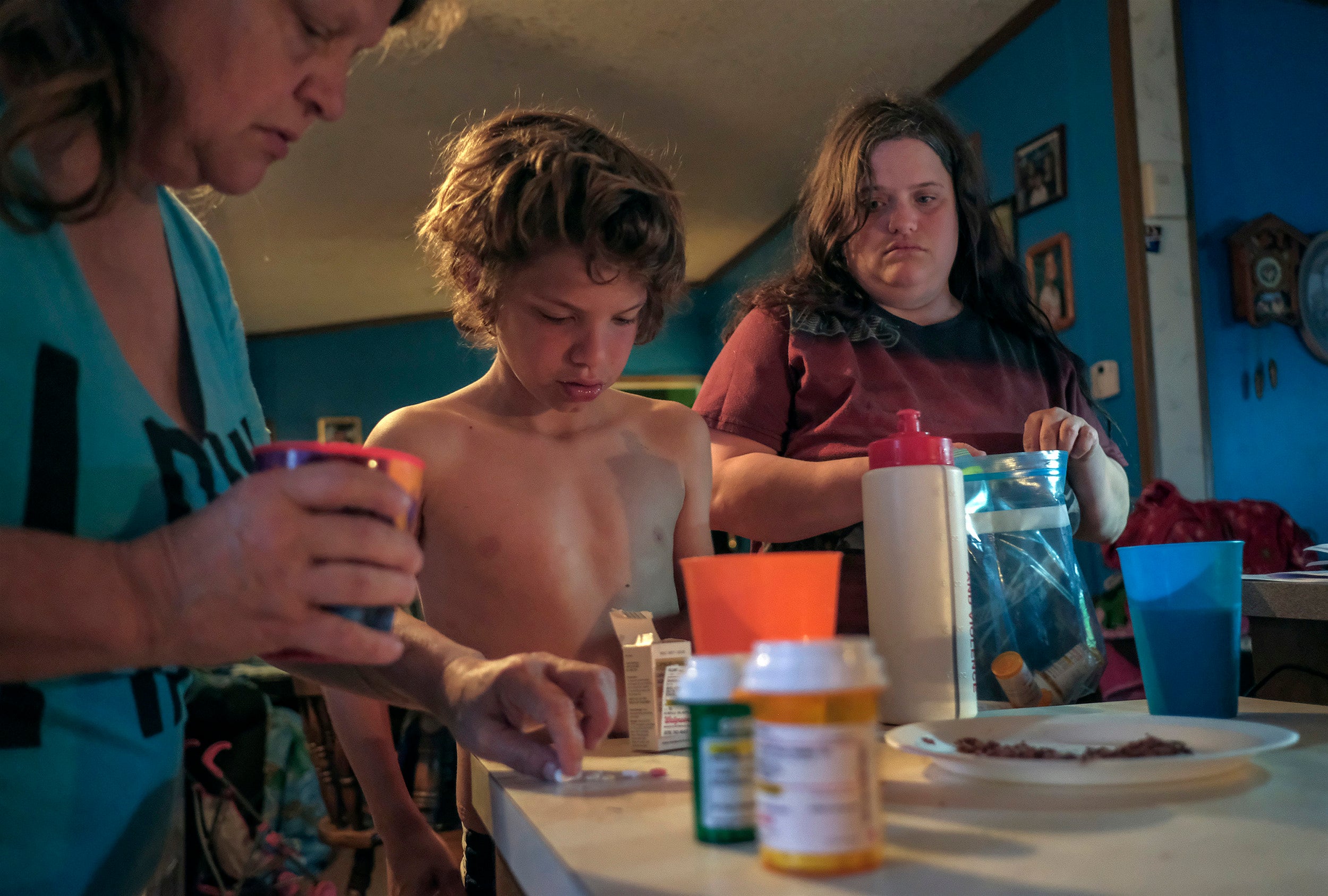 Kathy Strait takes medication along with her grandson, William Tidwell, and daughter, Franny Tidwell