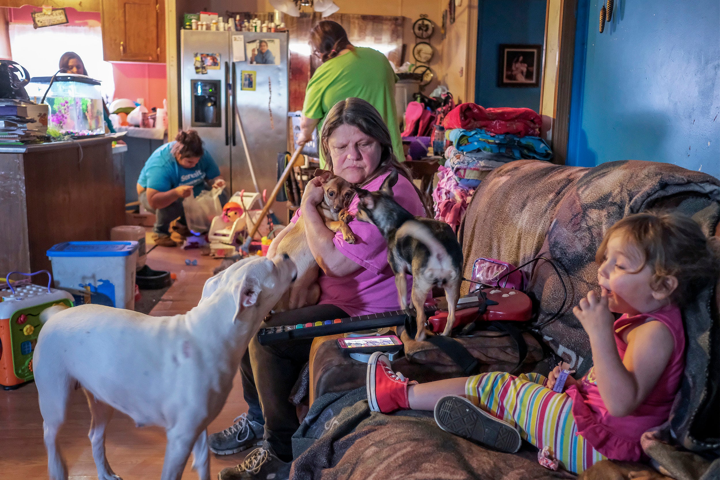 Kathy surrounded by pets and her family