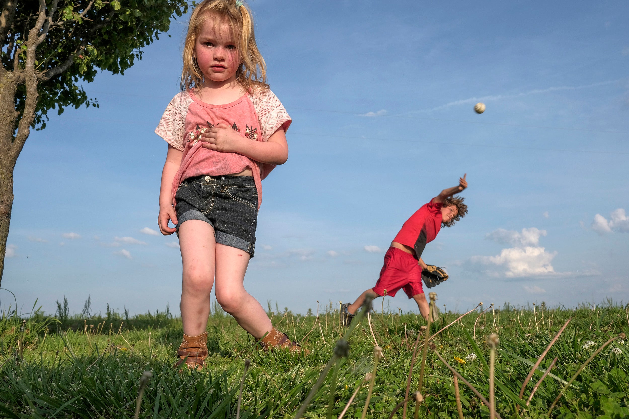 Bella, 4, and Dale, 10, play on their lawn