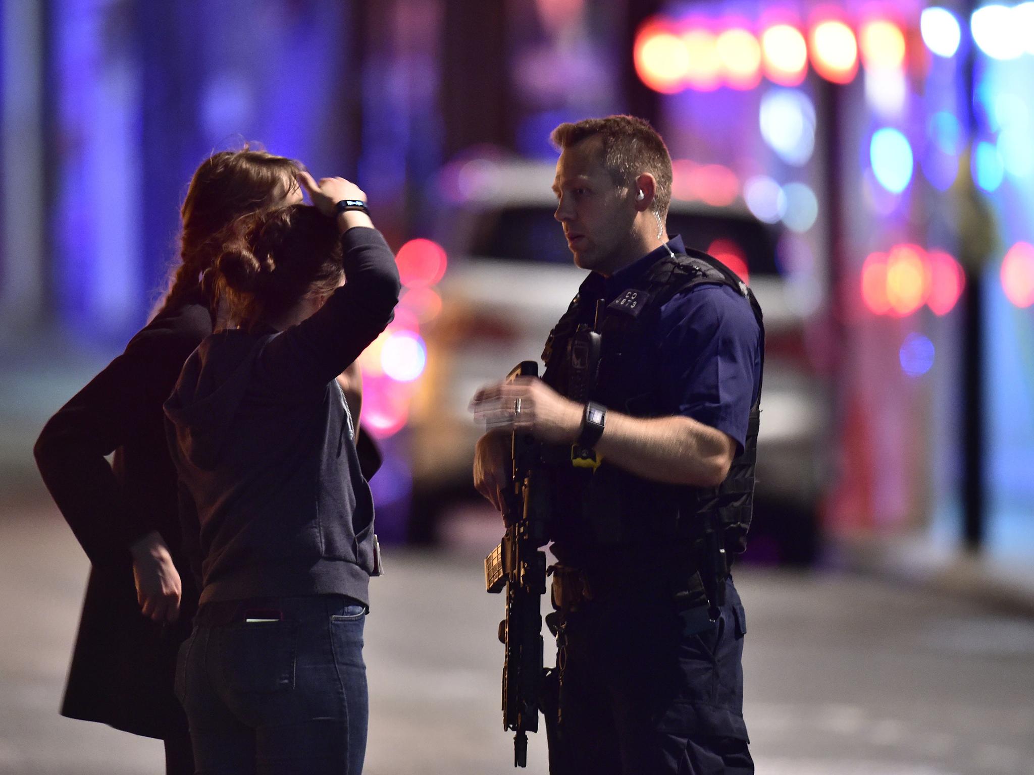 Armed Police talk to members of the public outside London Bridge Hospital as police are dealing with a "major incident" at London Bridge