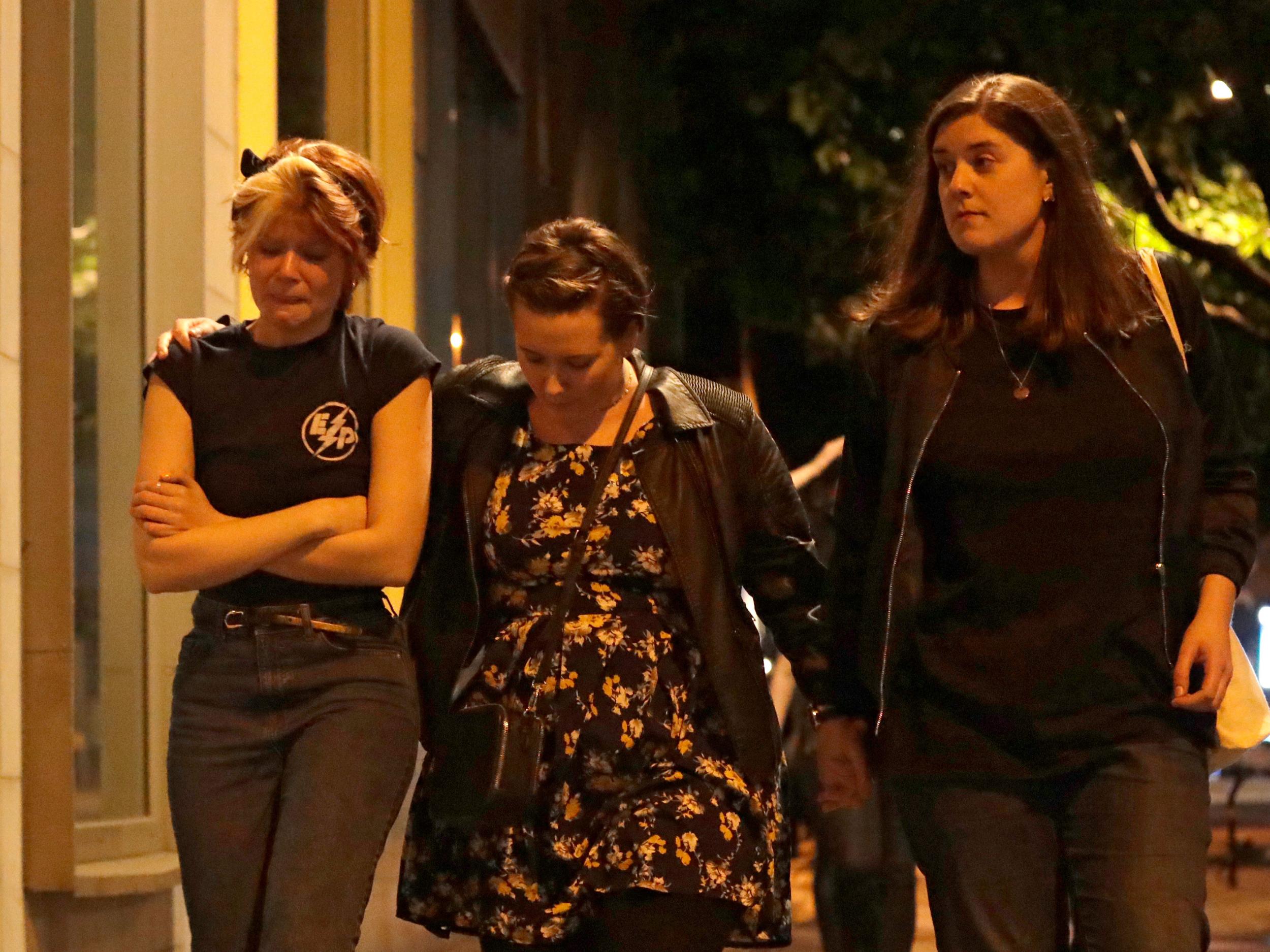 People walk away about 10 minutes after midnight from inside a police cordon after an attack in London