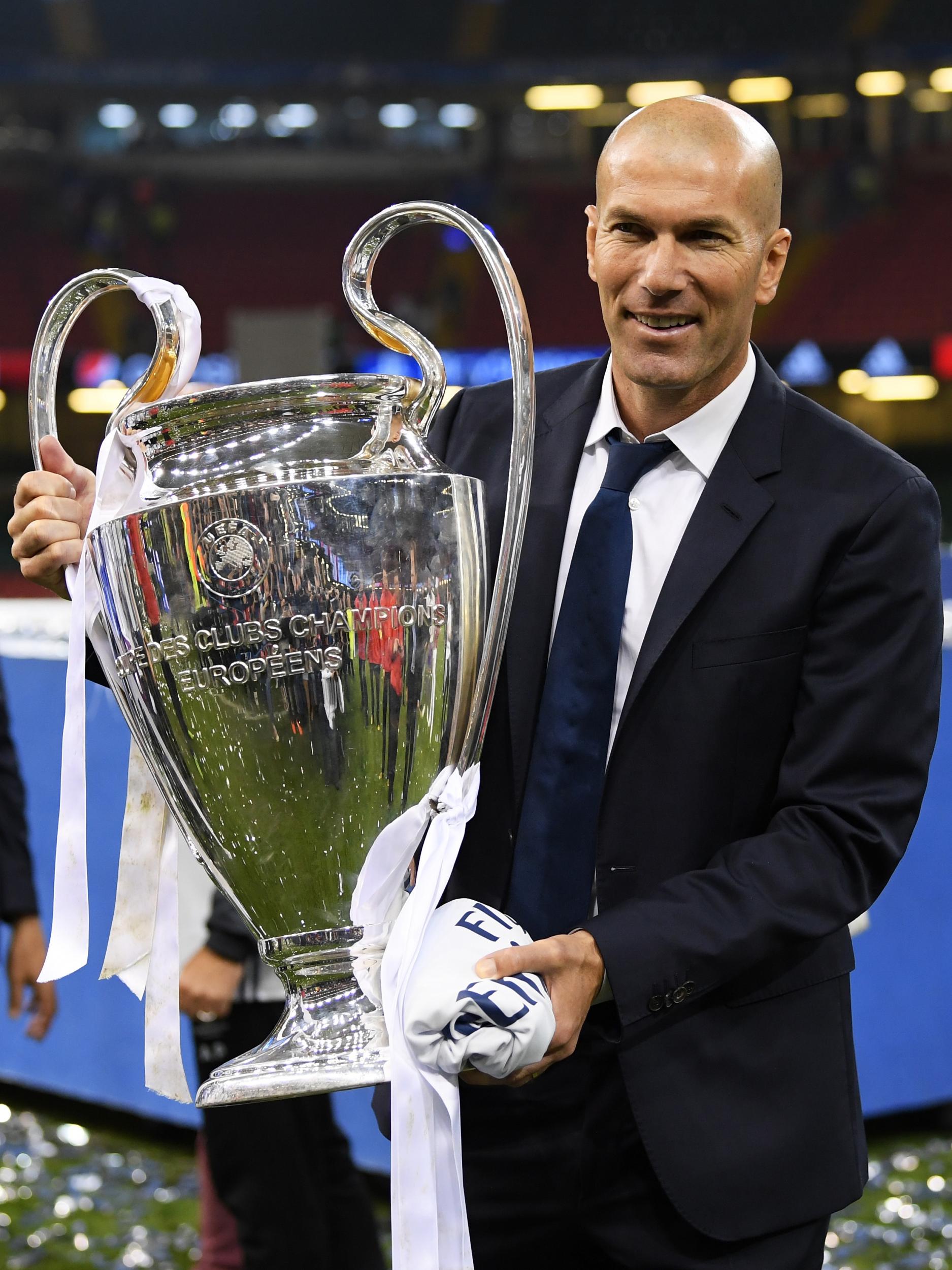 Zidane posing with the Champions League trophy after Real's win