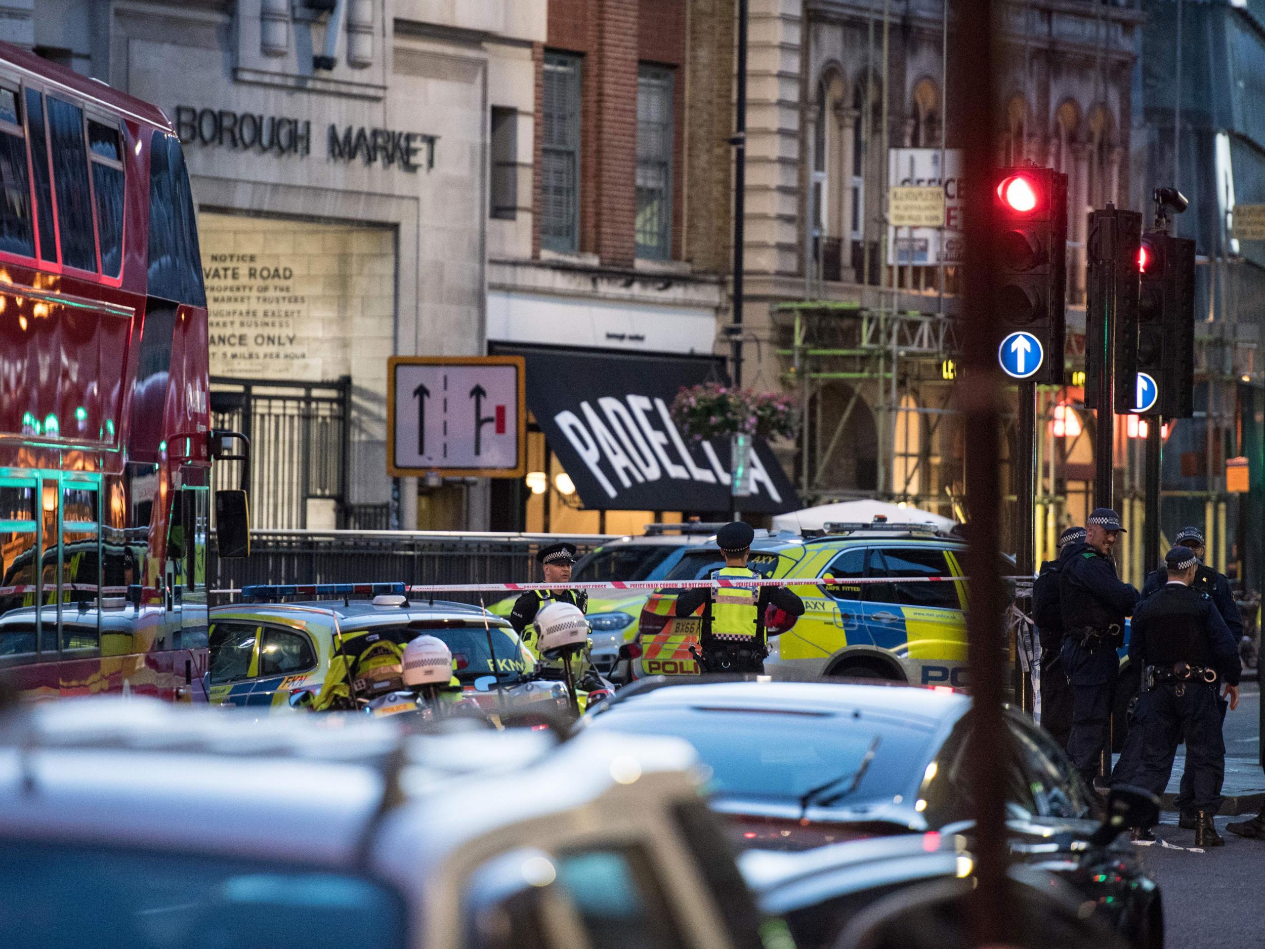 Police officers and emergency response vehicles are seen on the street outside Borough Market after terror attack