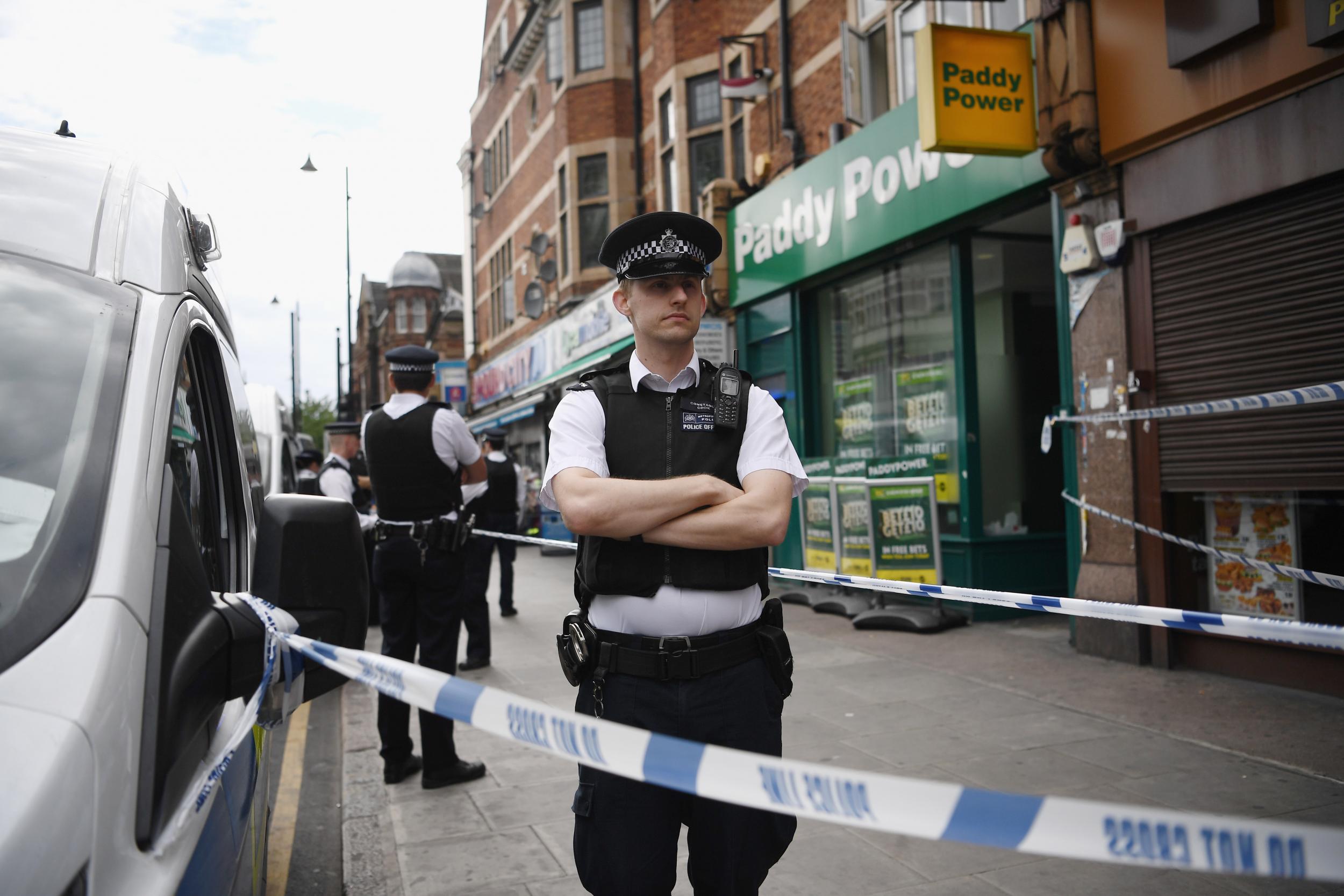 Police outside a property in East Ham which has been raided by officers