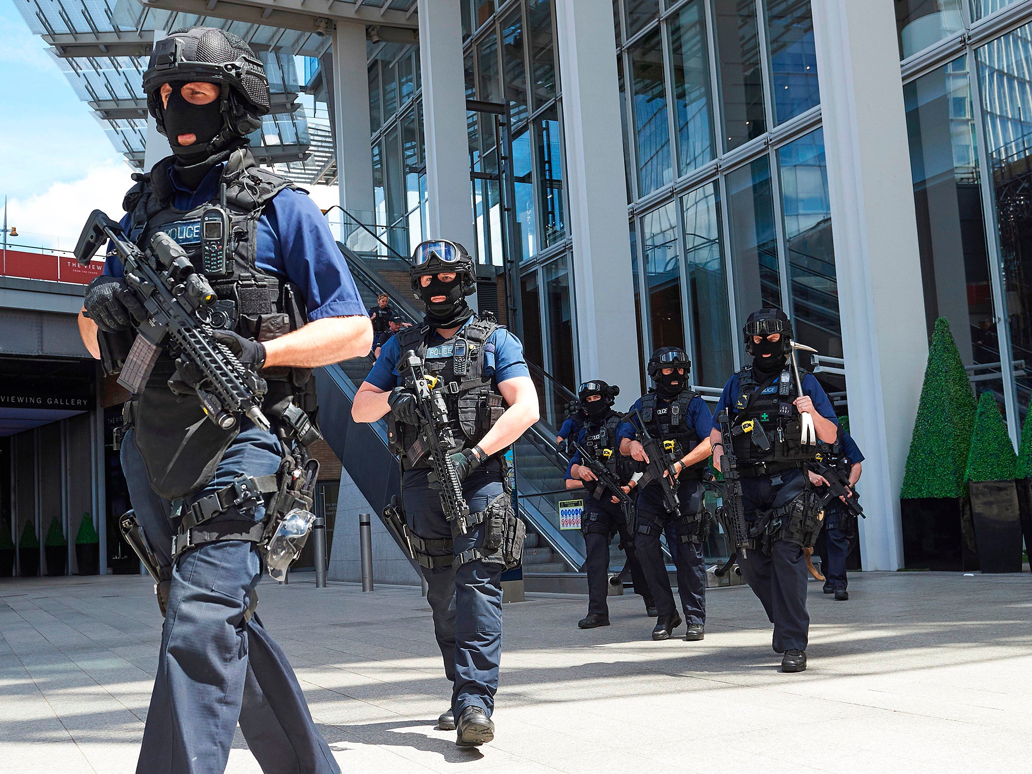 Armed police officers patrol outside The Shard tower and London Bridge railway station in London (AFP/Getty Images)